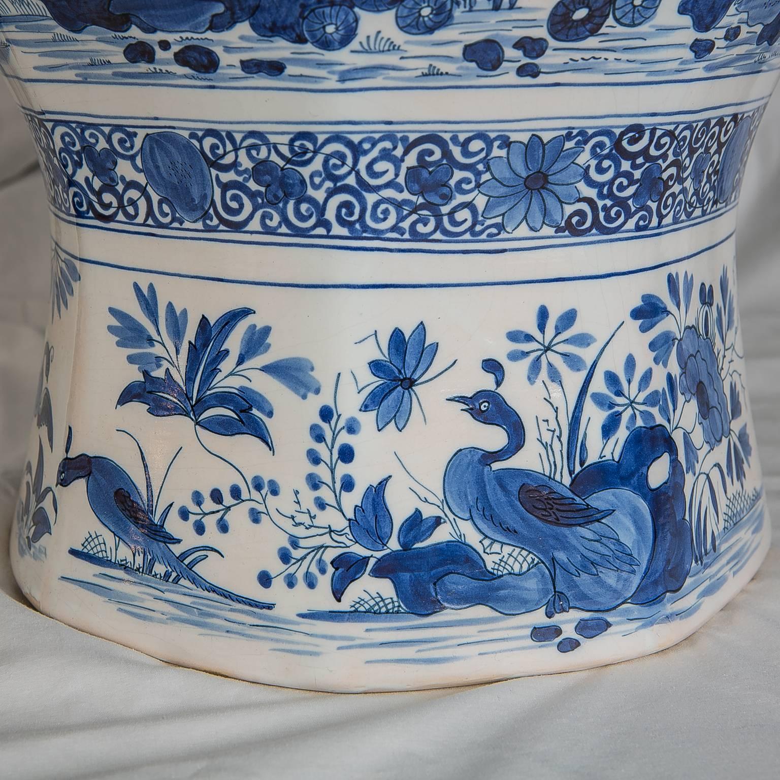 A pair of massive Dutch Delft octagonal, ginger jars painted in cobalt blue and white. Beautifully decorated with a continuous scene of a garden filled with flowers, songbirds and peacocks. The scenes show the exceptional and enduring charm of
