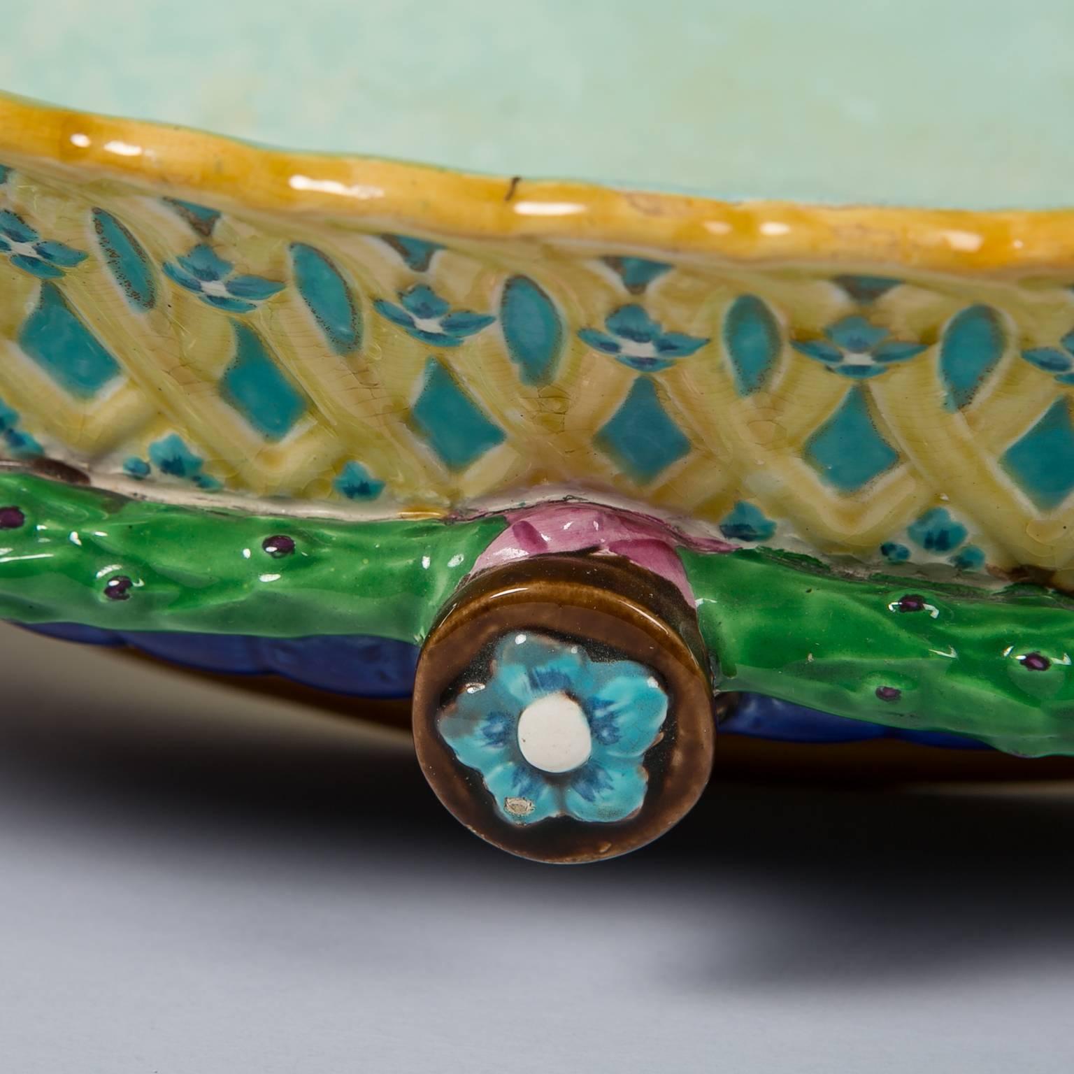 A very pretty Wedgwood Majolica planter molded in relief and splashed with bright, bold enamels of turquoise, pink, green, blue, and yellow. Even though this was created in 1872 pieces like this are timeless. Today this planter would enhance either