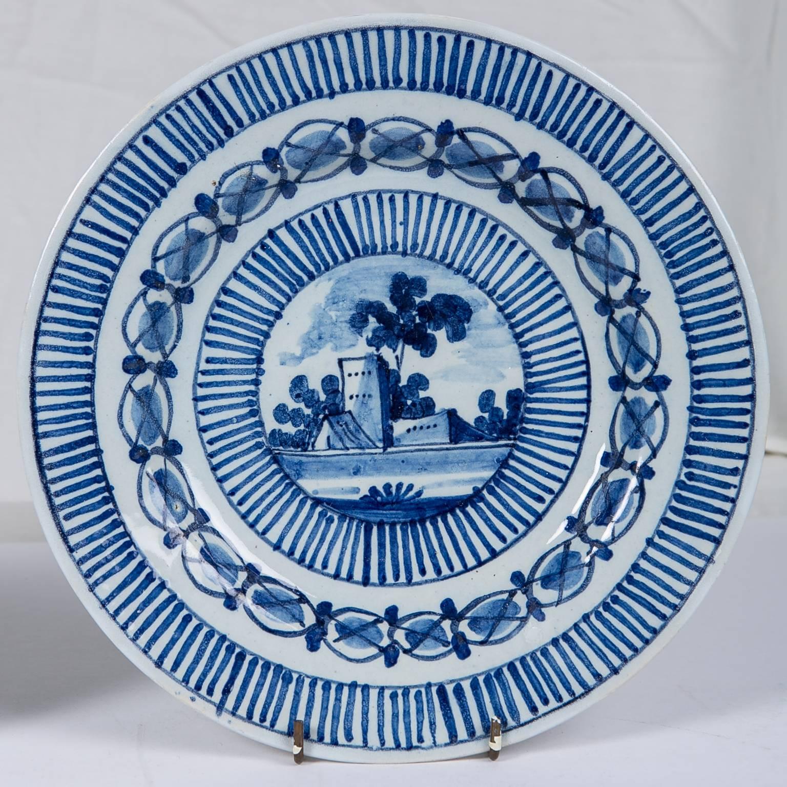 A picturesque castle scene is the focal point of this pair of Dutch Delft Blue and White plates.
The radiating lines framing the castle are repeated along the edge of the plate creating a very striking effect.
This pair is a wonderful representation