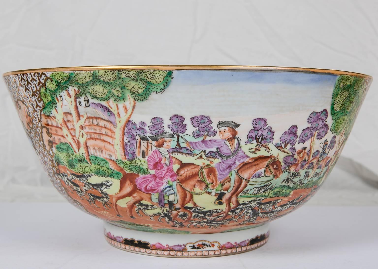 A large reproduction Chinese famille rose hunt bowl, the original Qianlong, circa 1760. The bowl shows western figures riding in a verdant landscape. There are several scenes: the meet, which is the assembly of the riders before the hunt. Full cry,