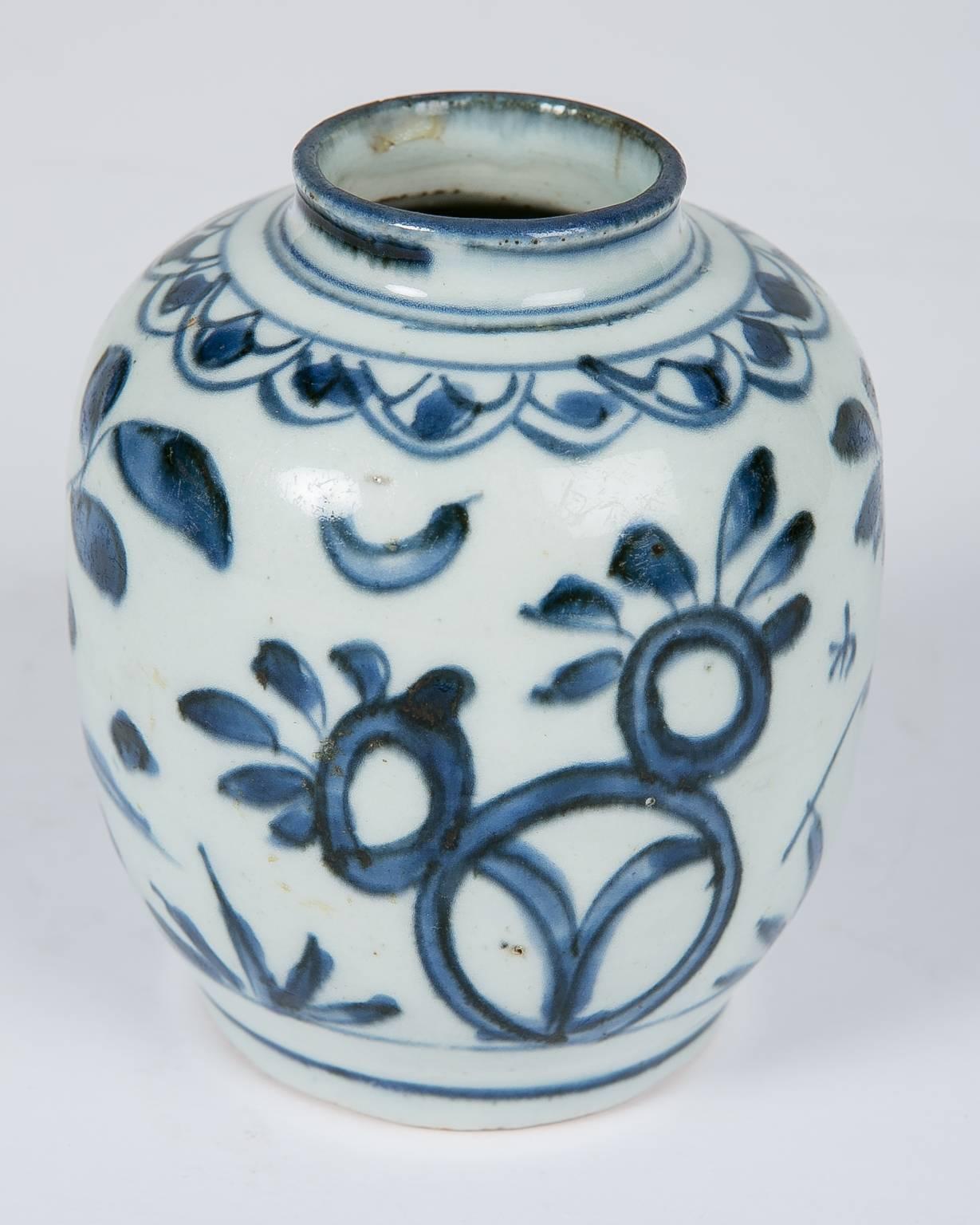 We are pleased to offer this Chinese blue and white small vase of Zhangzhou porcelain made in the early 17th century. Painted in underglaze cobalt blue the vase is decorated across the top with a fishscale pattern.
The main body is decorated with a