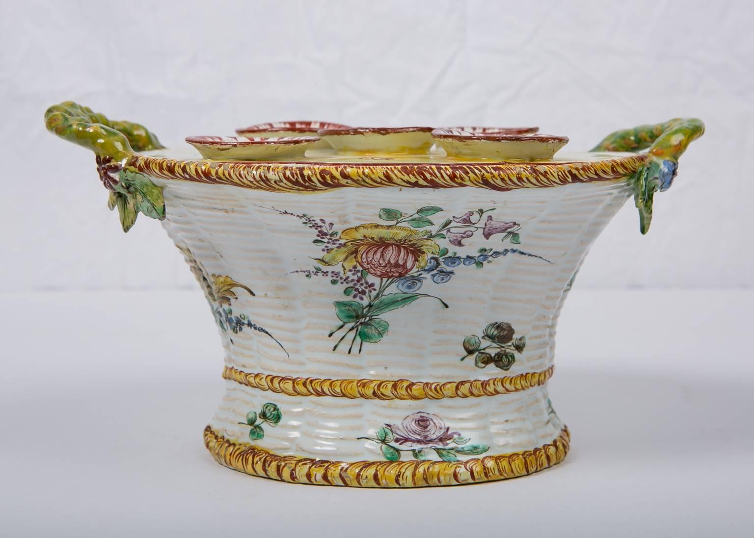 WHY WE LOVE IT: It's beautiful.
We are pleased to offer this French faience planter or bough pot modeled as a flower basket. The top has five openings for small bouquets of flowers or flower branches. It also has four smaller openings for single