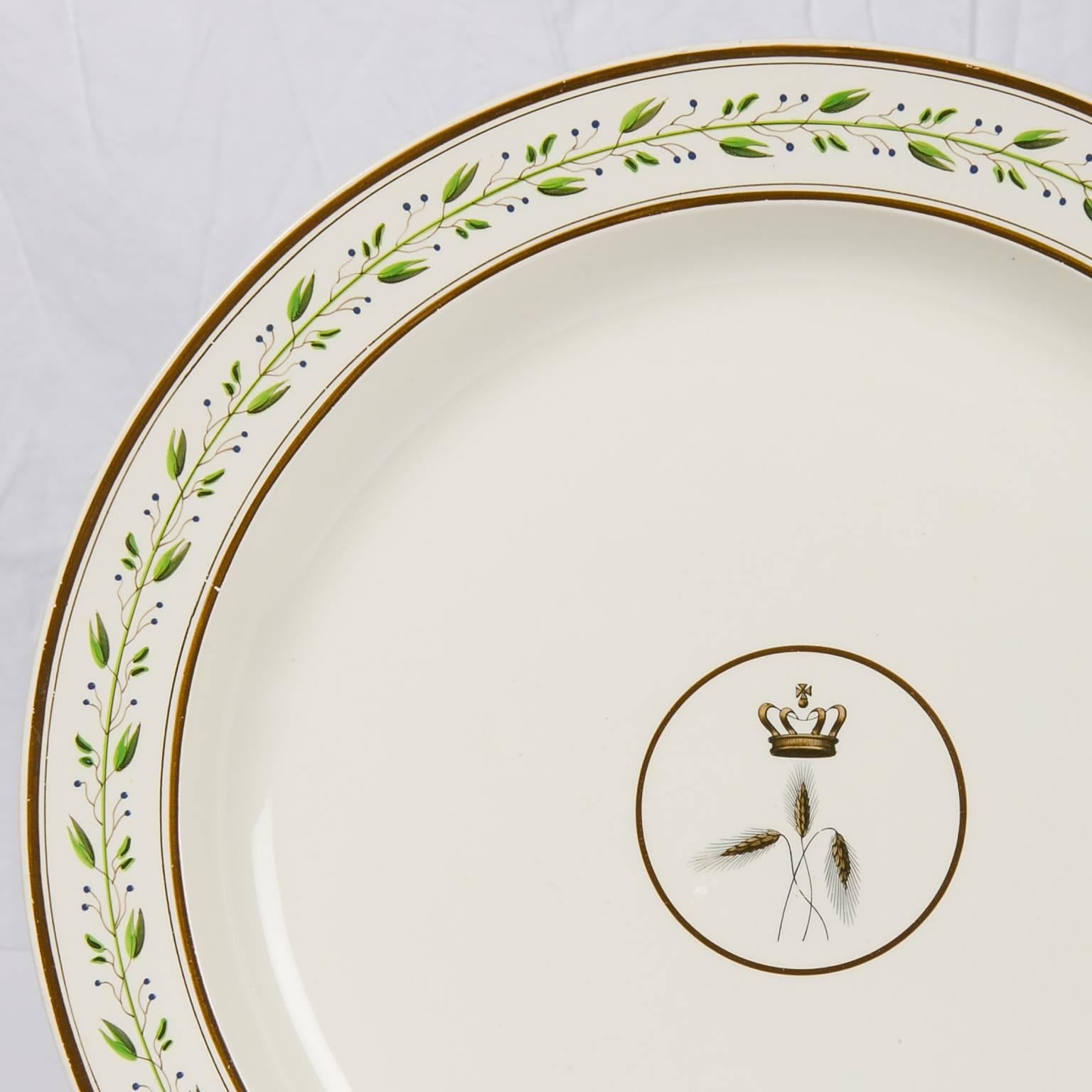 A large Wedgwood charger with a crest at the center showing a crown above three stalks of wheat.
The crown is similar although not exactly replicating St Edward's Crown, the crown of British Royalty since the 13th century. The crown represents the