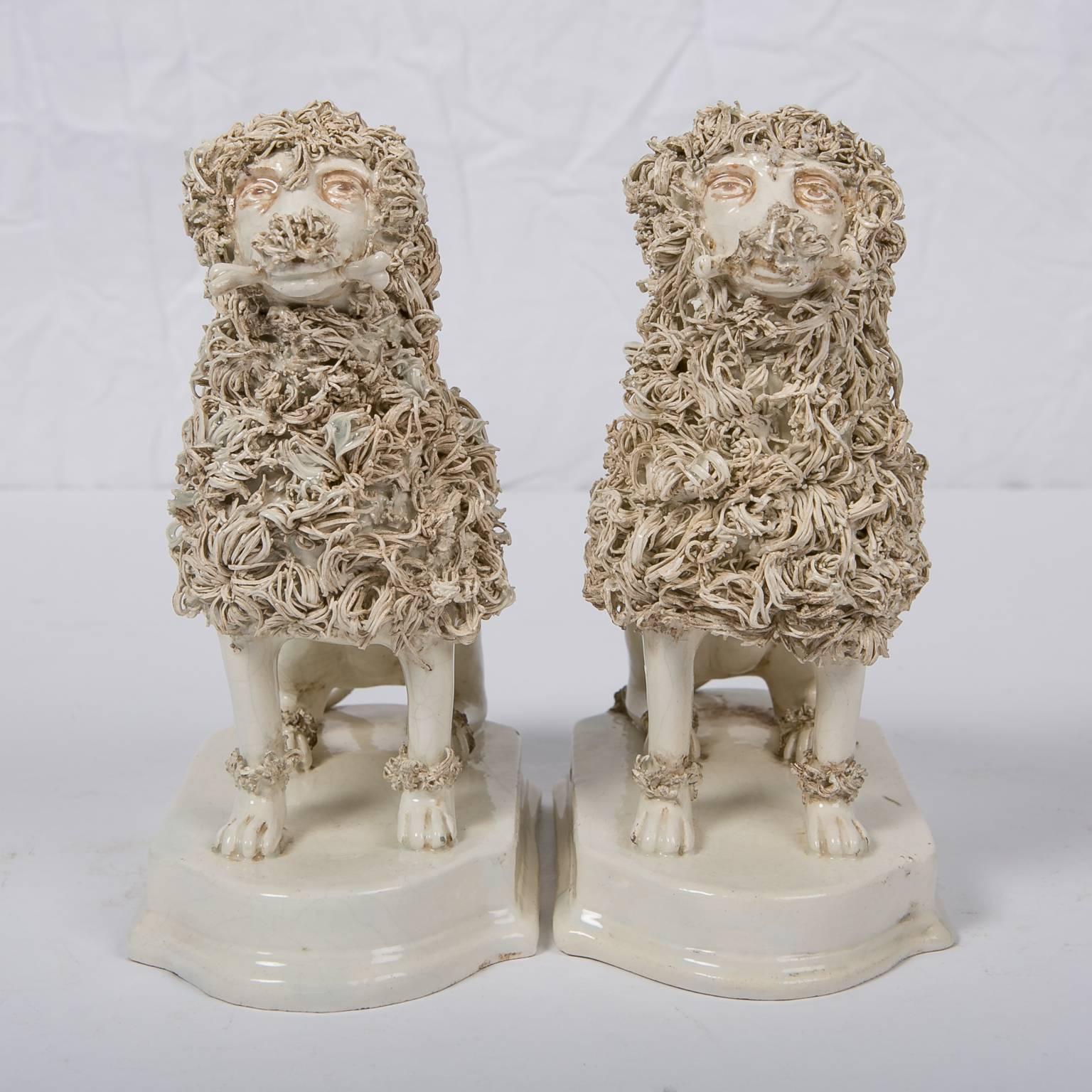 We are pleased to offer this pair of wonderful Antique Creamware Dogs Made by Nove di Bassano. These creamware poodles were made in Italy in the first quarter of the 19th century. Each is modelled seated, on a stepped base. The technique for making