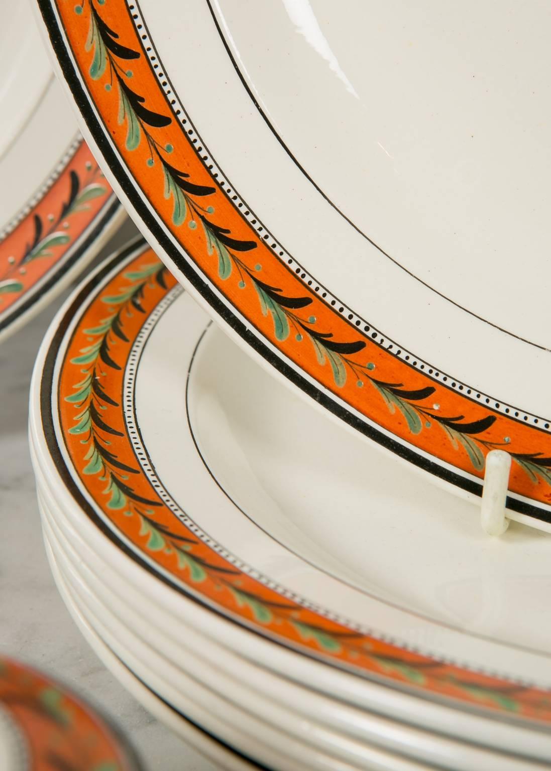 This set of creamware dishes features a beautiful border with a pattern of laurel painted in green and black on an orange ground. Laurel is a neoclassical motif. A laurel wreath is a symbol of victory and honor dating back to Greek and Roman times.

