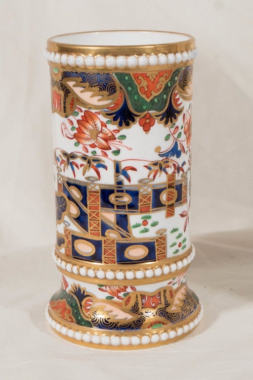 Painted in Imari colors of orange, green, blue and gilt this popular Spode pattern features a design with flowers, bamboo and a zigzag garden fence. Spode's pattern 