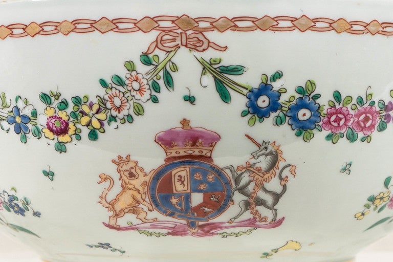 We are pleased to offer this large antique porcelain punch bowl with an armorial showing a lion and a unicorn. Made in the late 19th century by the French firm of Samson, Edme et Cie. this bowl is in the Chinese export style. In addition to the