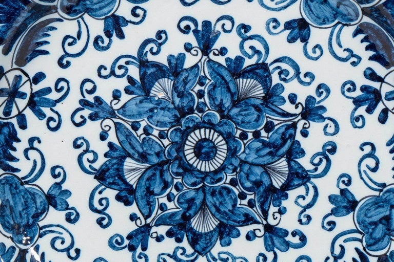 A Dutch Delft Blue and White Charger and a Matching Pair of Dishes
