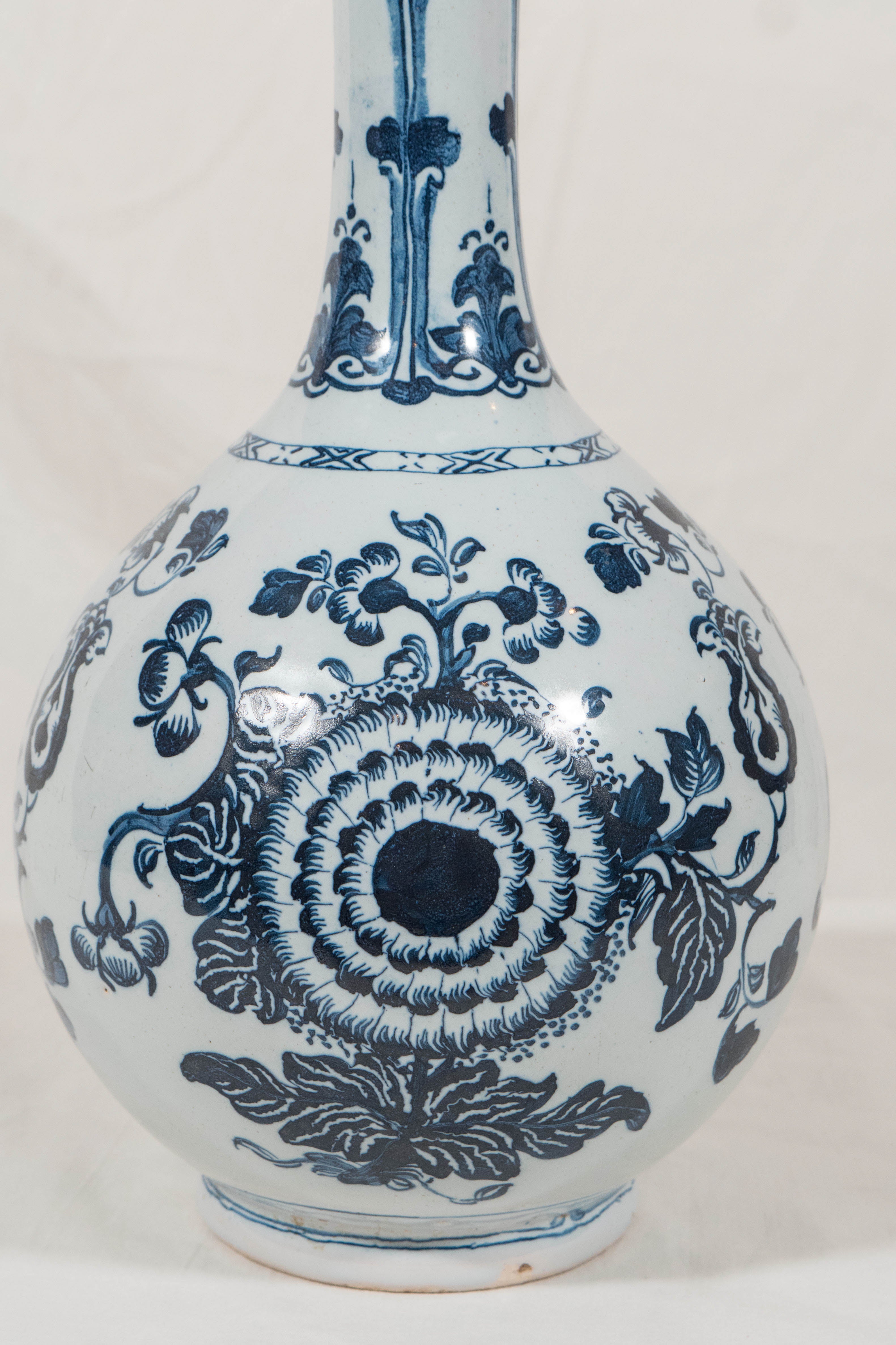 We are pleased to offer this antique English Delft Blue and White bottle vase made in the mid 1700's in London. This delftware vase is painted in deep inky cobalt Blue and White under a pale blue glaze.  It is the deepest cobalt blue we have ever