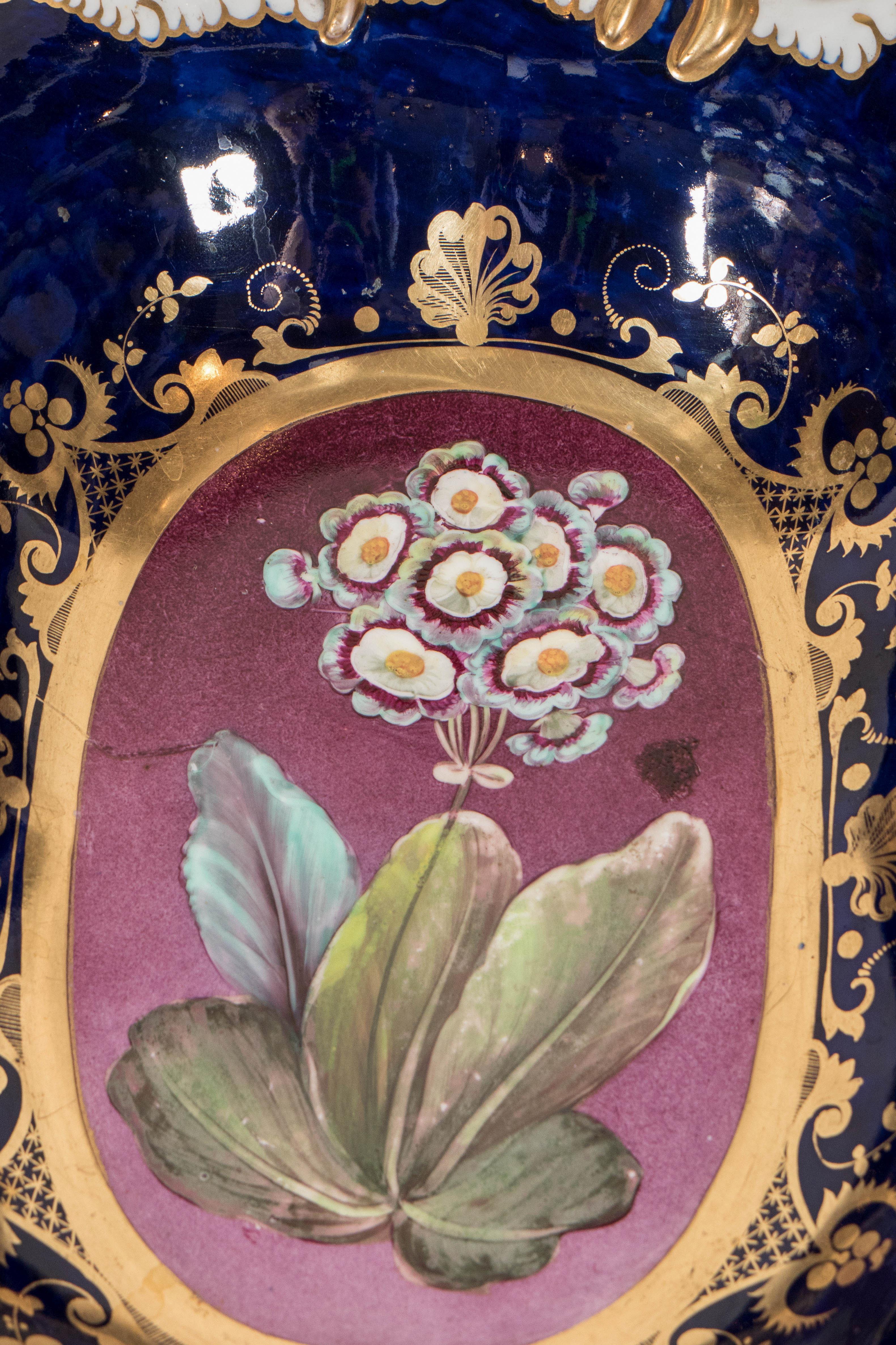 We are pleased to offer this beautiful rectangular antique English porcelain fruit bowl showing a primula on purple surrounded by cobalt blue. The bowl was made by Hicks and Meigh in England at the beginning of the 19th century. The combination of