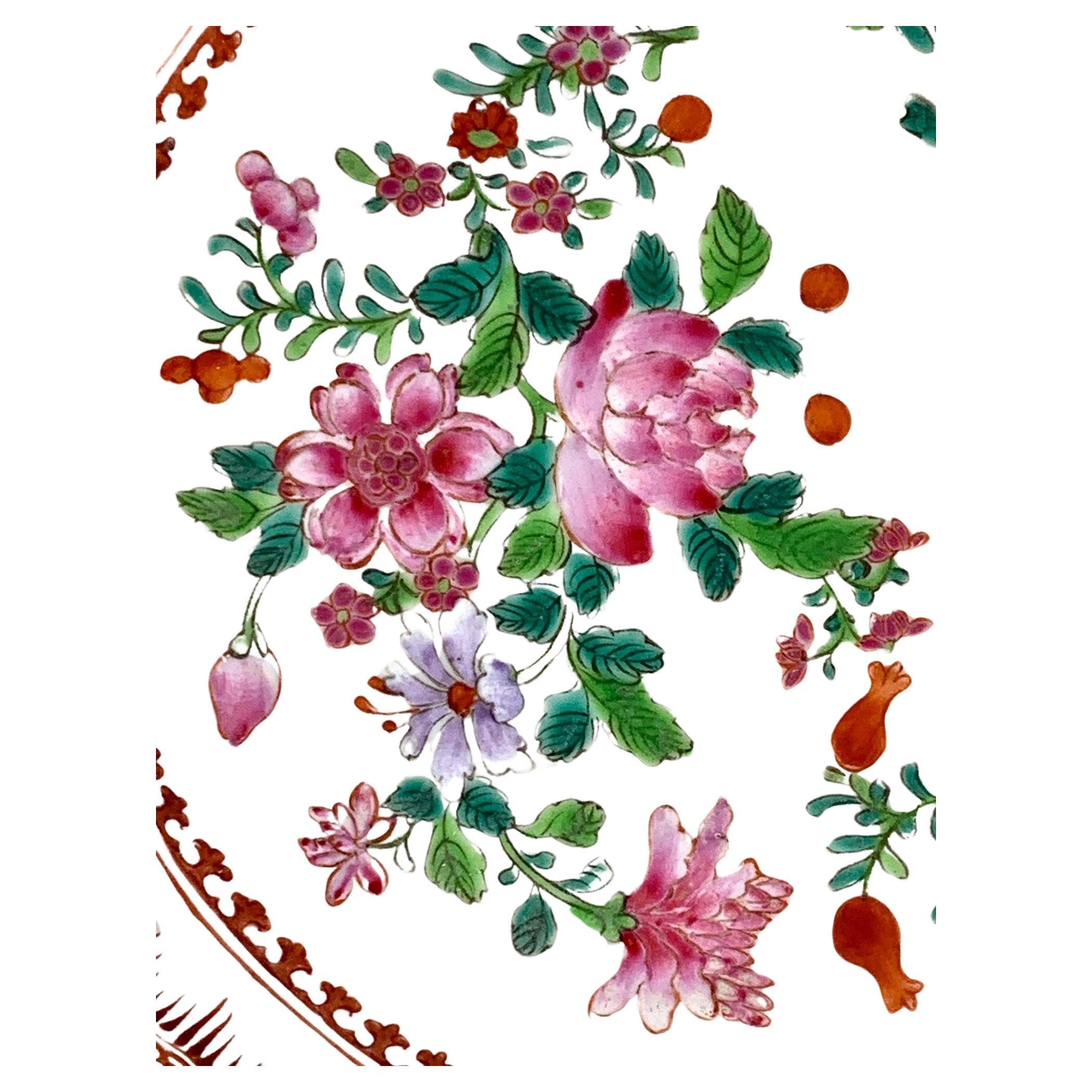 This set of four Chinese porcelain dishes are hand painted in Famille Rose colors.
The center is filled with beautiful flowers separated by leaves in two tones of green.
The predominant colors are pink, orange, green, and turquoise with small