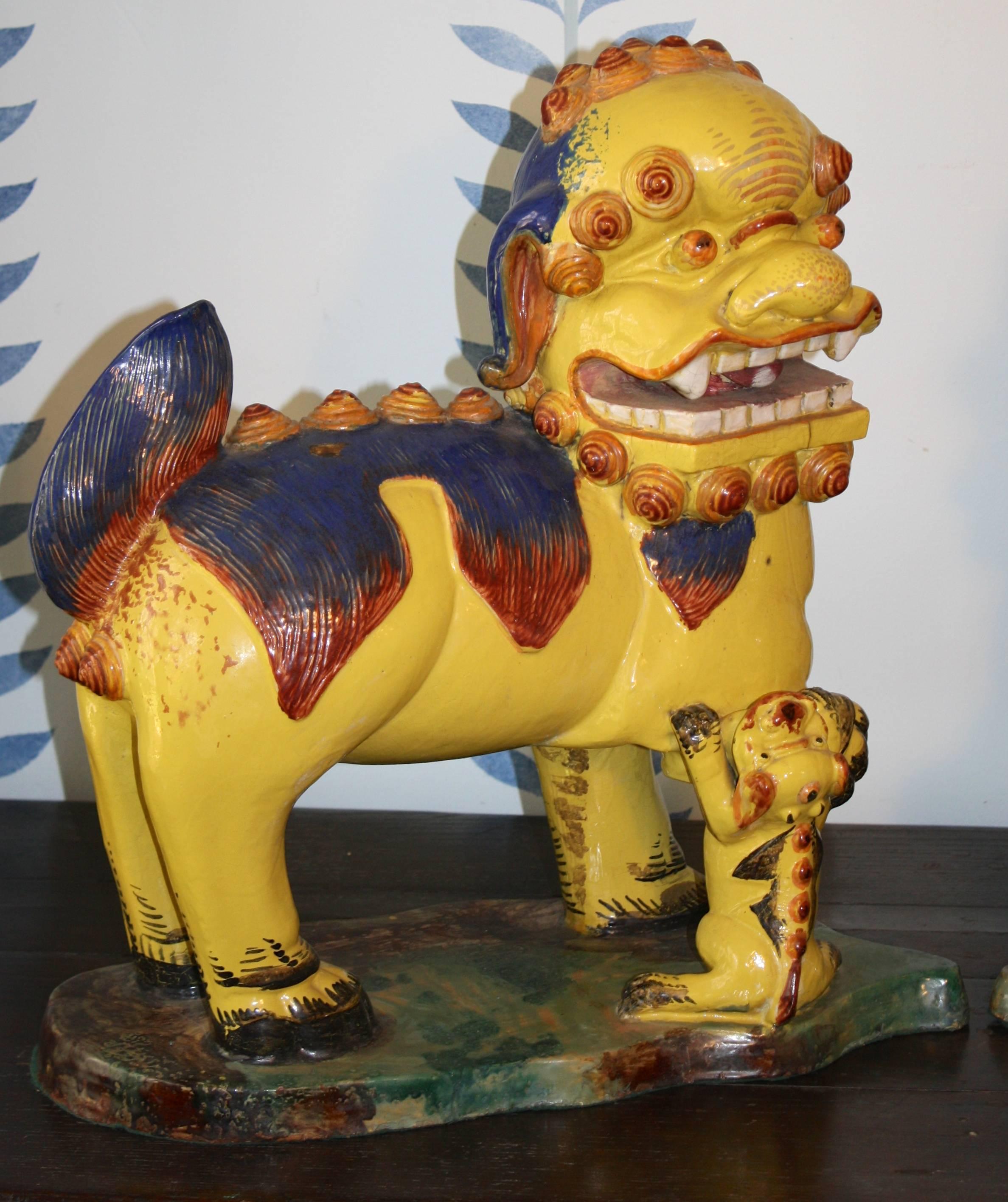 An oversized facing pair of ceramic pottery Fu Lionesses with cubs, dating from the last quarter of the 18th century Qing Dynasty at the kilns of Chiuchow;  a city in the eastern Guangdong province of the China. 
This Fu pair may be non-invasively