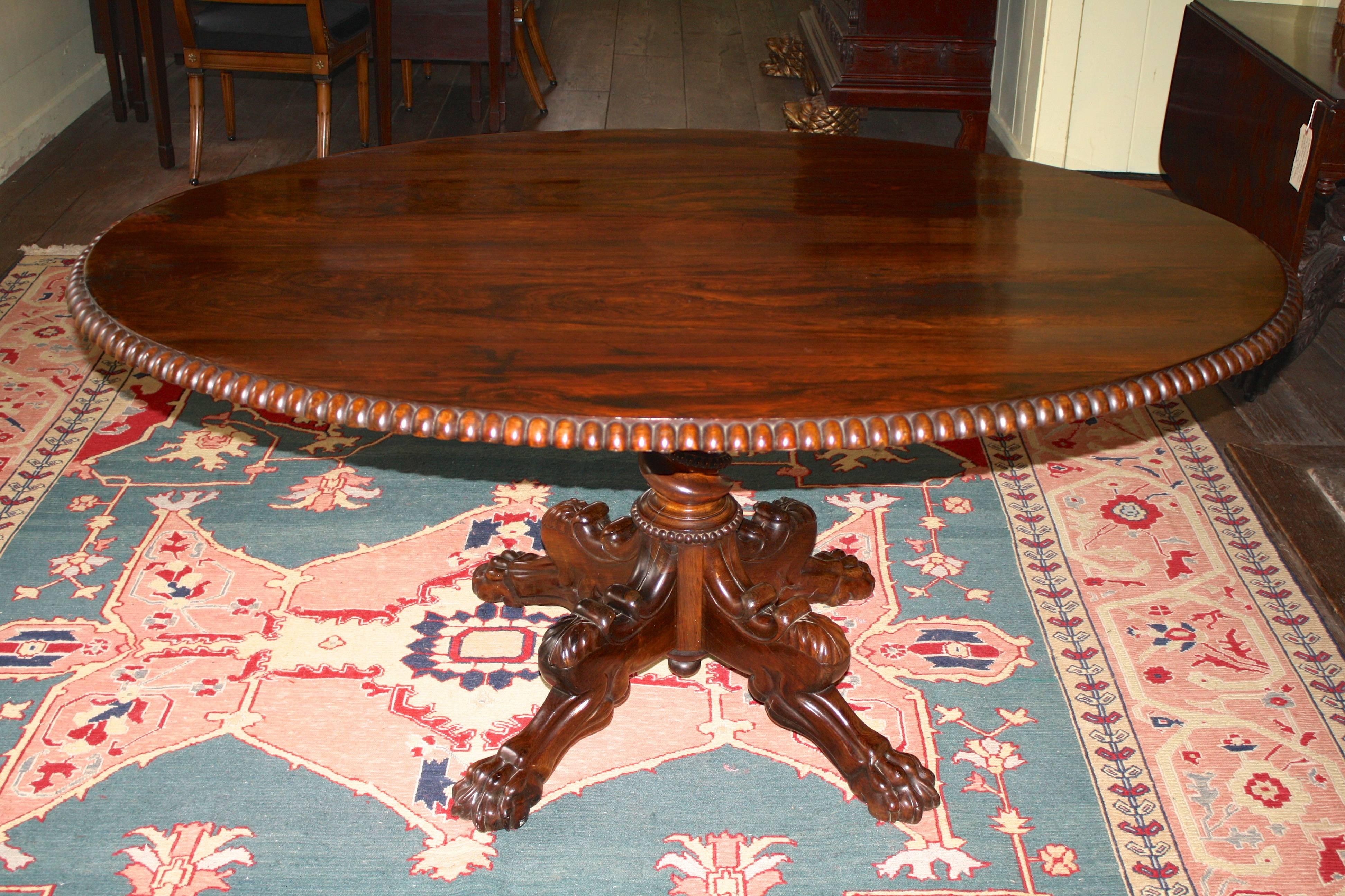 Grand and profusely hand-carved solid rosewood oval tilt-top center table, made in India during the reign of William IV; acquired by British watercolorist C. Bigot whose stamp is impressed on the table's block. (Image #9) Bigot created a series of