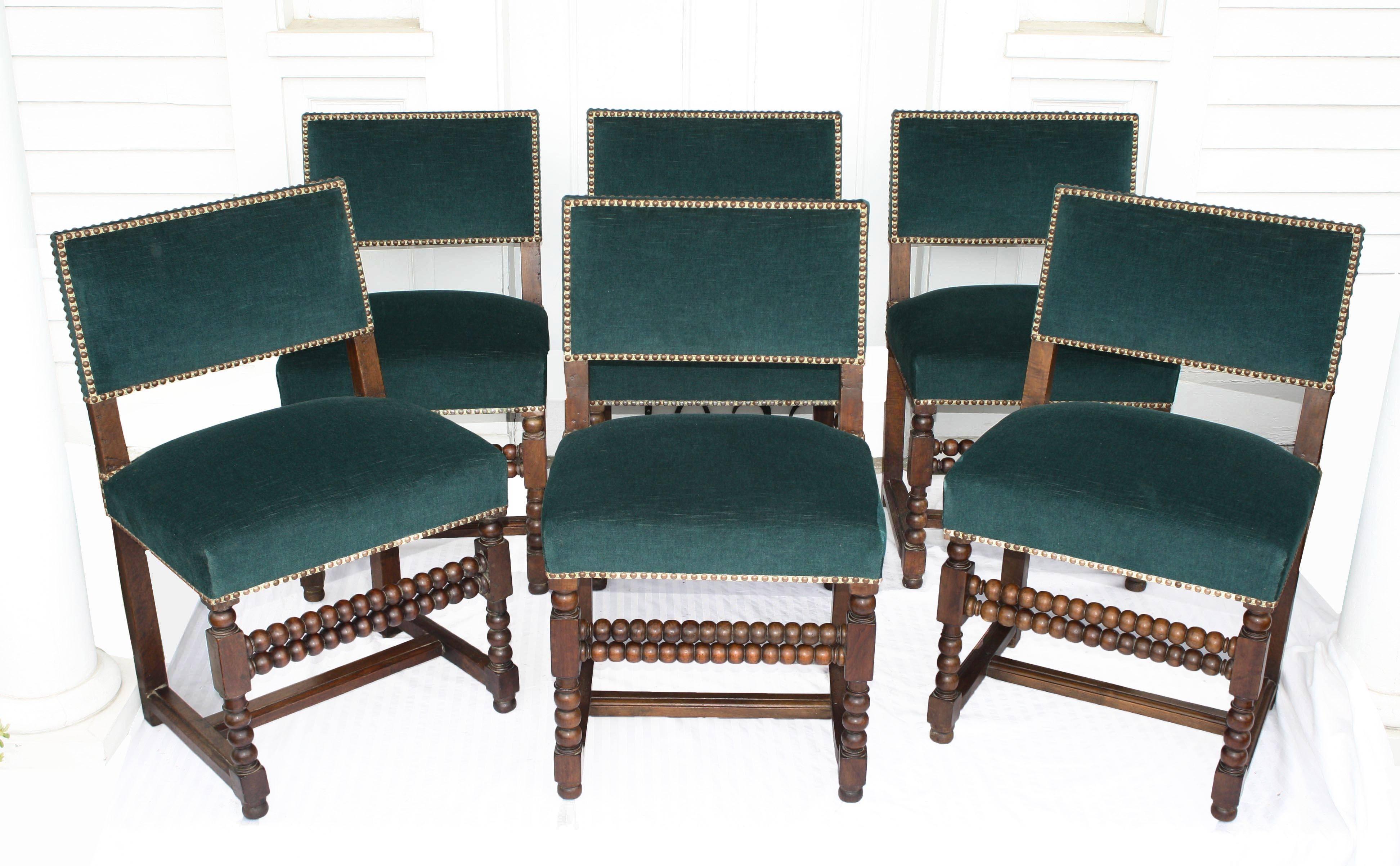 An extraordinary set of six mid-17th century Louis XIII late Renaissance period dining side chairs. Hand-turned and carved oak, dual turned front stretchers, flat H-stretchers, and solid planed oak back-boards; recently re-upholstered to today's