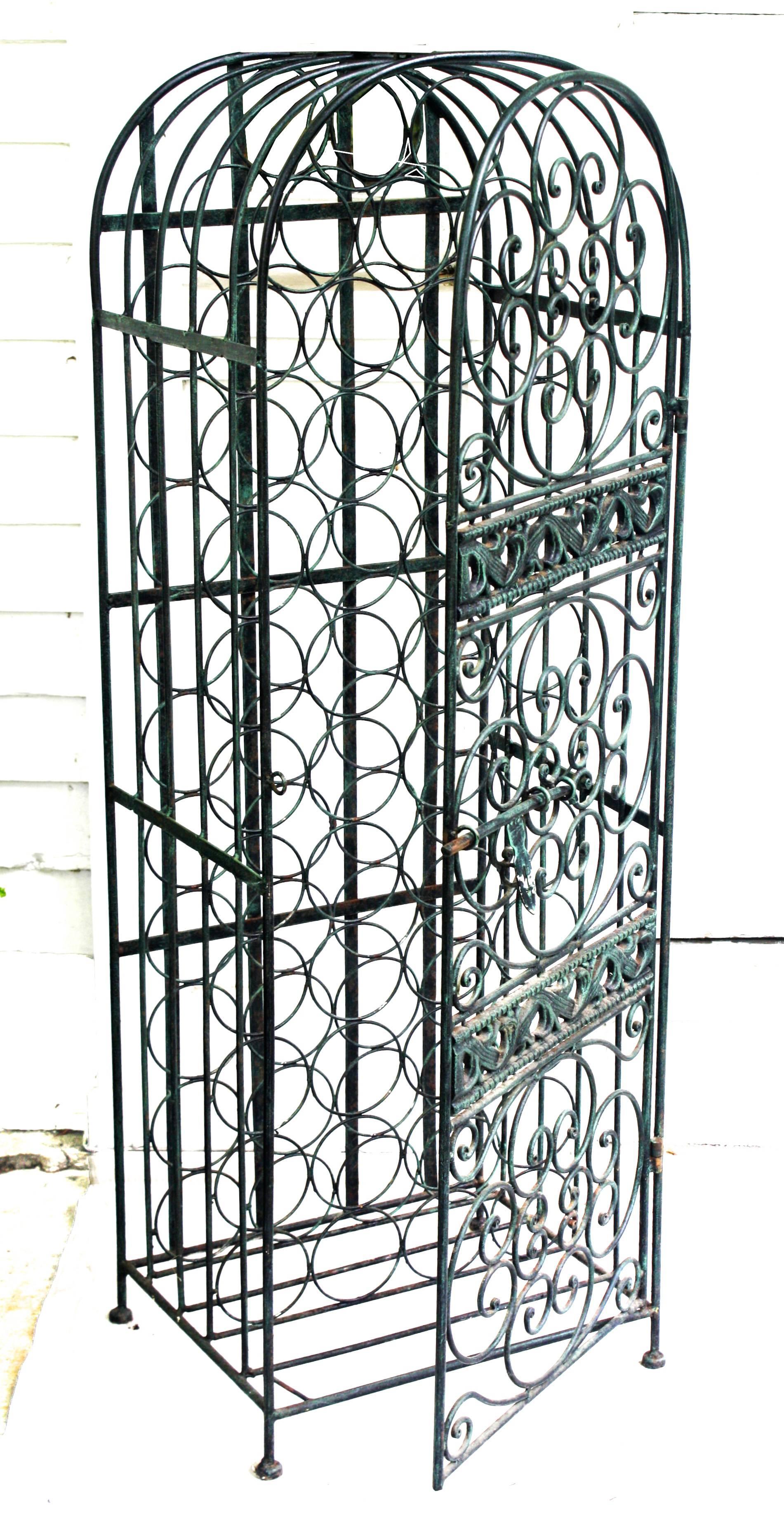 A highly decorative and lockable black wrought iron wine rack of 45 bottle capacity. Arthur Umanoff's earliest furniture designs were produced by Post Modern Ltd., a New York company in which he was a partner in the early 1950s.
 