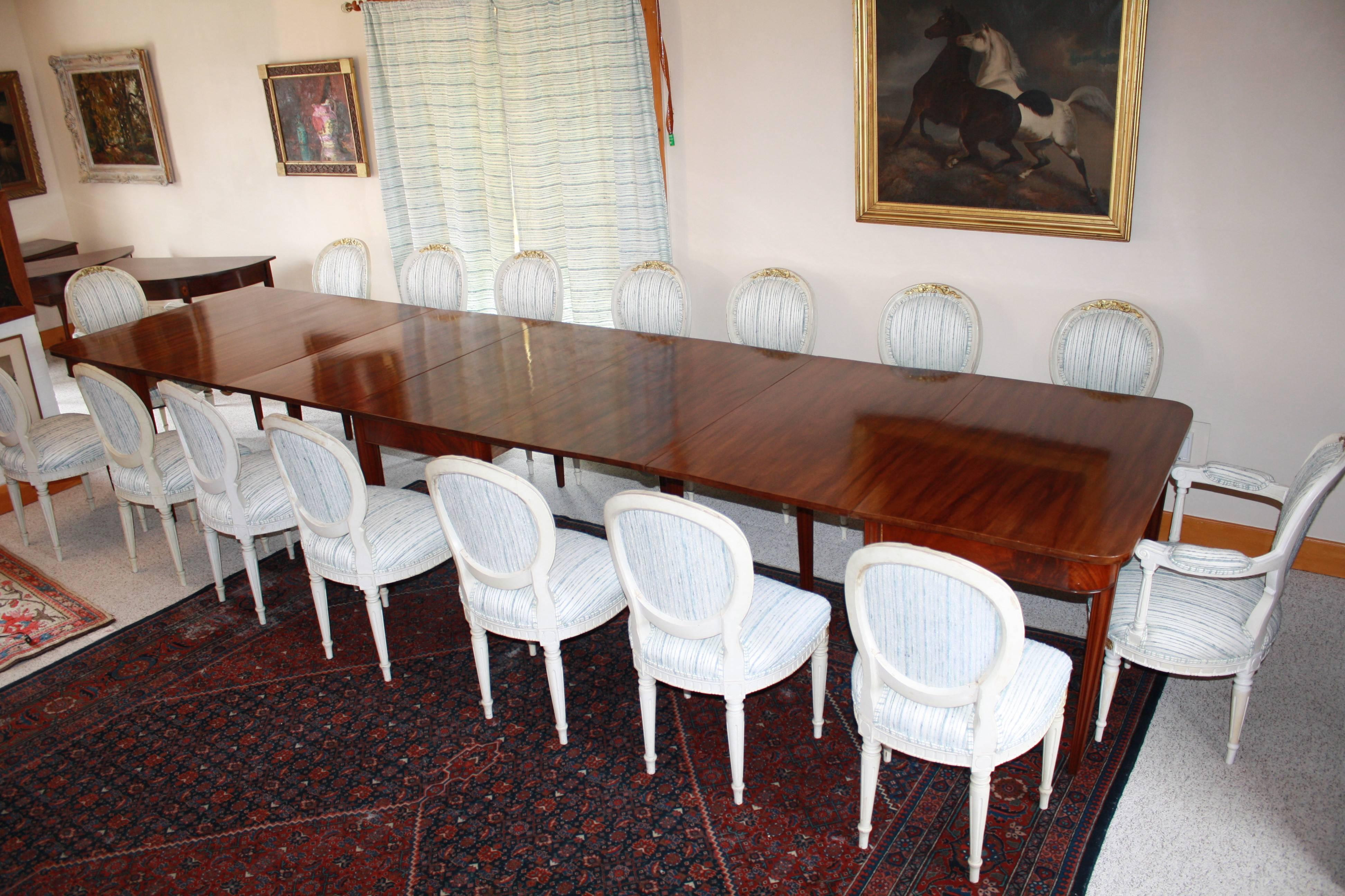 An American Centennial tripartite banquet table in the Hepplewhite manner, bench-made in 1880 and acquired by the German Embassy in Washington D.C.  Handcrafted Honduran mahogany on tapering corner-fluted legs.  184 inches long, 48 inches wide, with