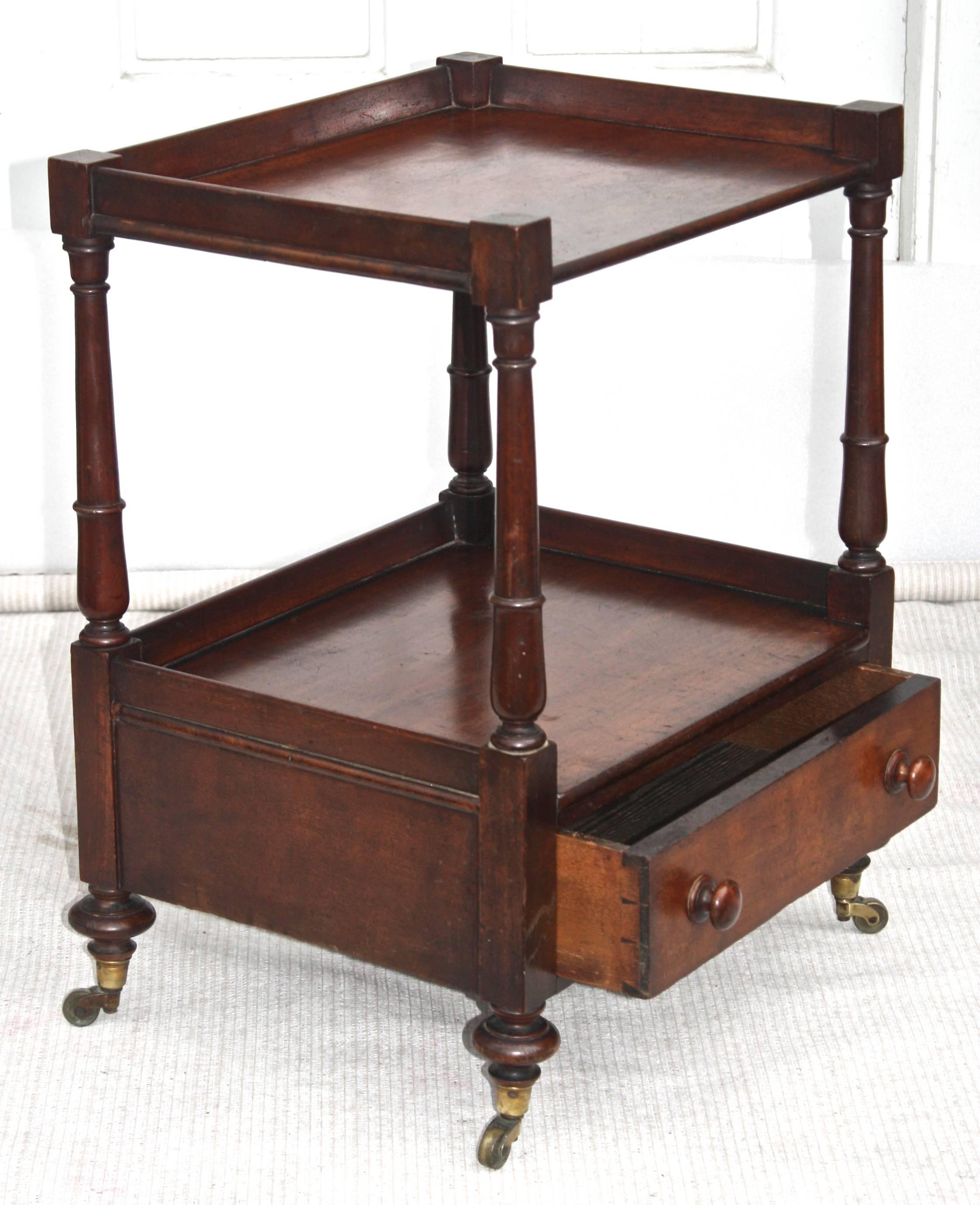 A very rare and highly unusual Regency period 'short' dumbwaiter table with drawer. Hand planed and turned mahogany, on brass castered small bun feet. 'Bespoke' for table-side wine and liquor service, it may be re-purposed aside upholstered lounge
