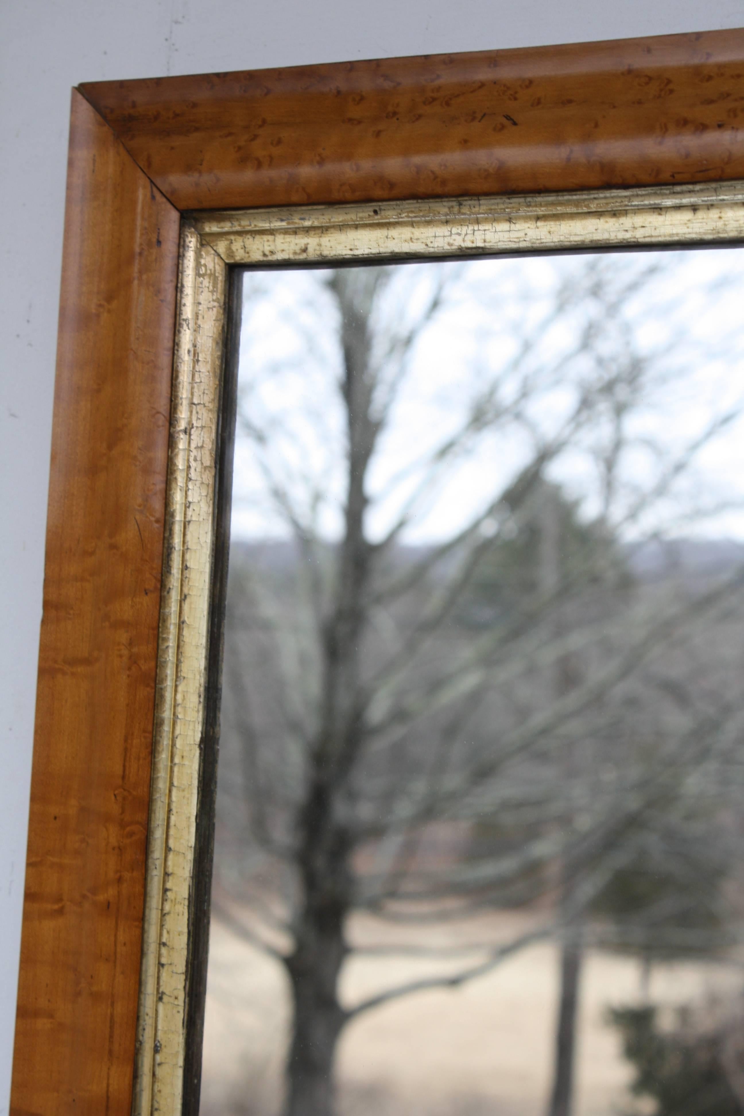 A birdseye maple framed mirror with a distinctive giltwood 'slip', dating from early in the second quarter of the 19th century.  Ex: the collection at a northeastern U.S. National Historic Register estate house with notable political connections.