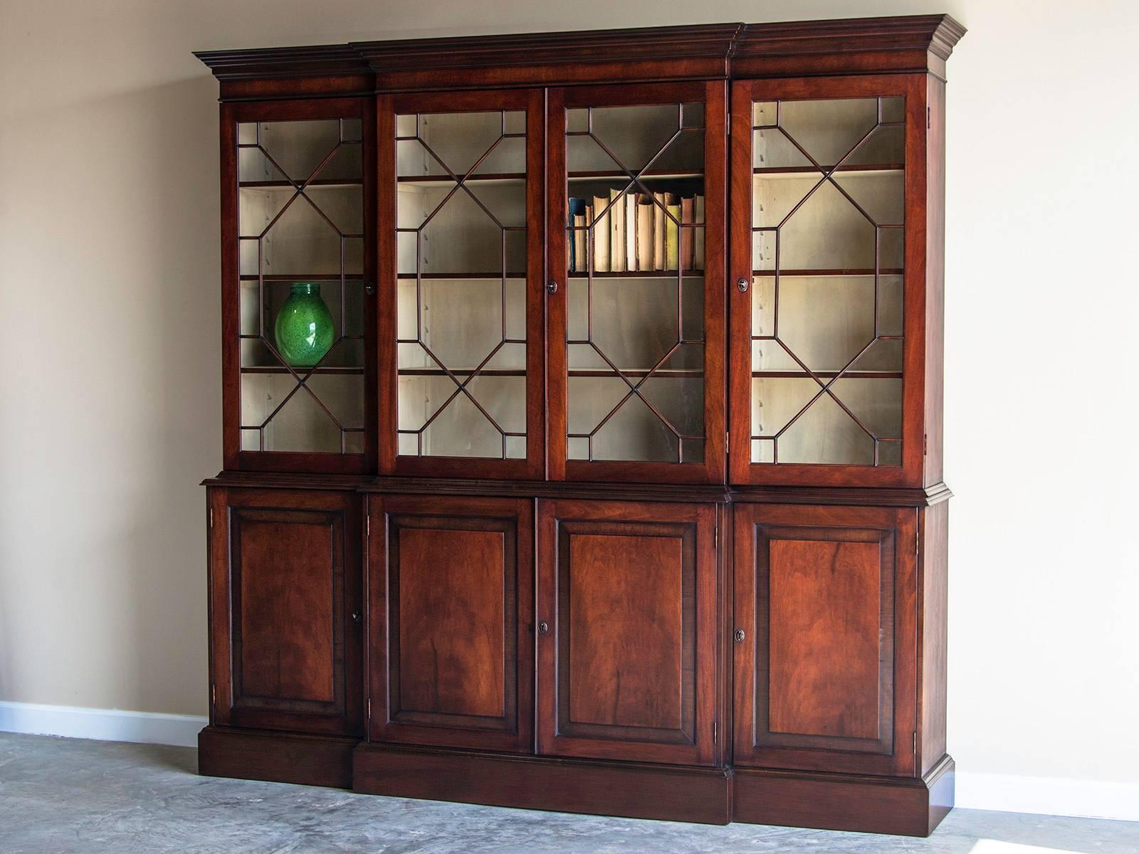 Receive our new selections direct from 1stdibs by email each week. Please click Follow Dealer below and see them first!

George III style mahogany breakfront crossbanded with rosewood from England. This elegant bookcase/display cabinet has been