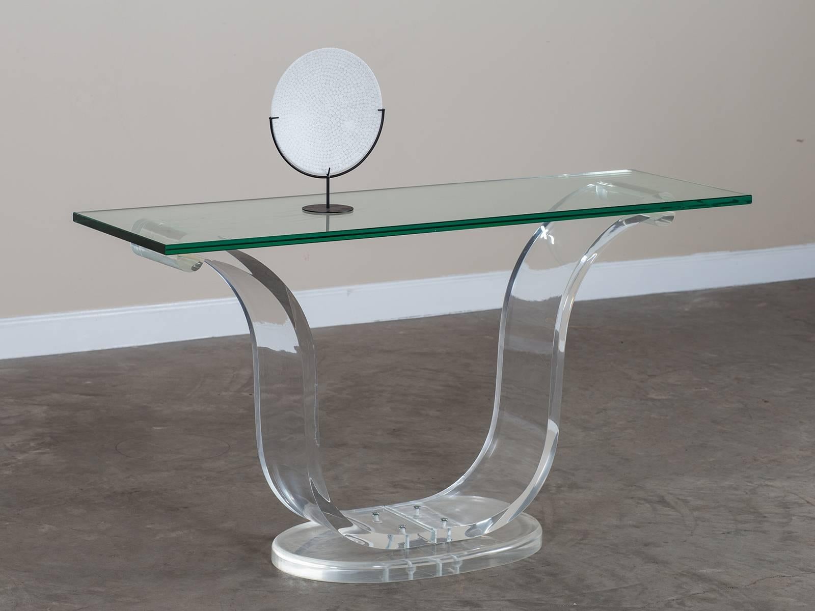 Receive our new selections direct from 1stdibs by email each week. Please click Follow Dealer below and see them first!

The elegant arch of the curve made by the Lucite base of this vintage French console table circa 1970 is completely