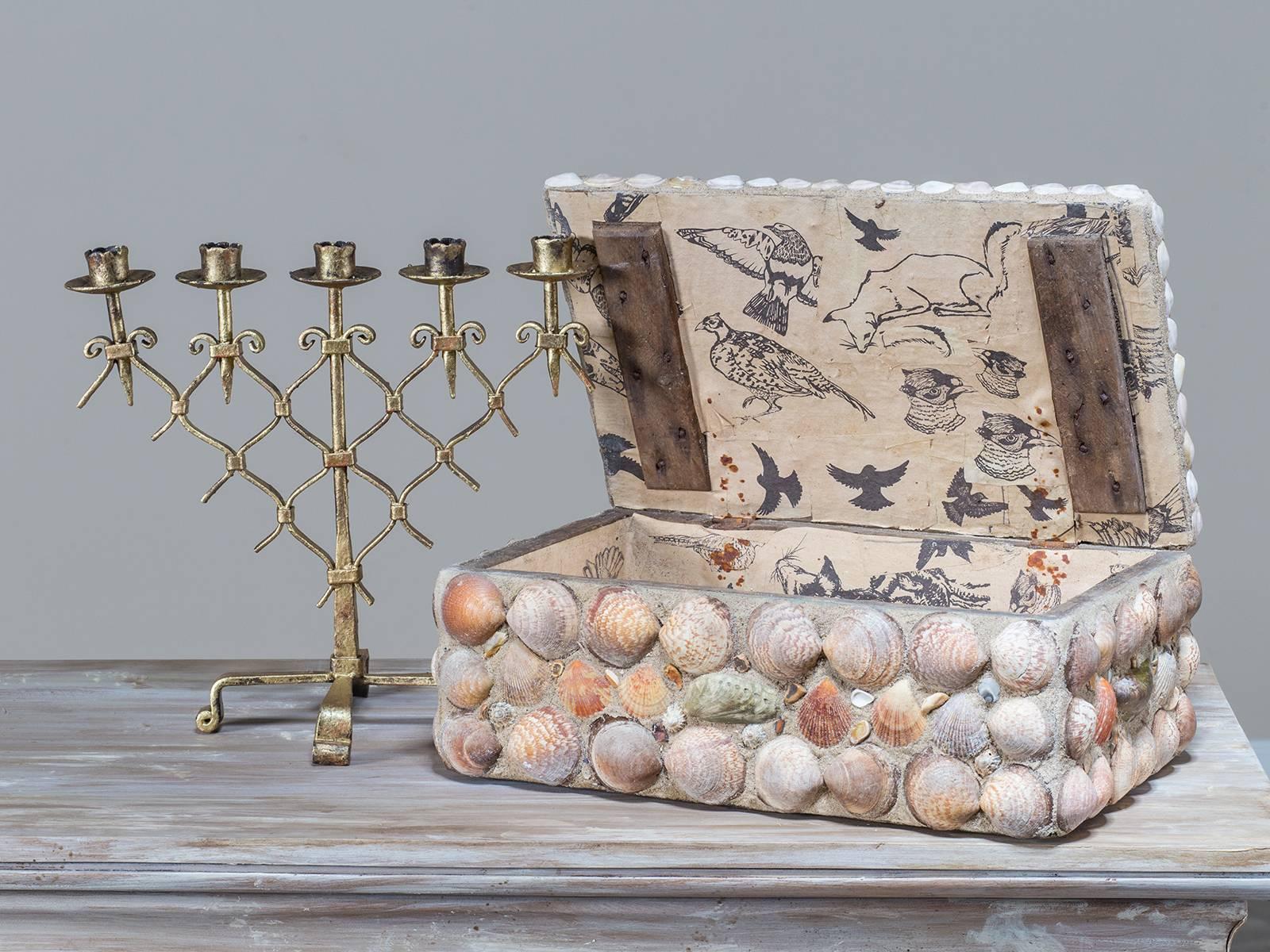 The grand scale of this vintage French sea shell box circa 1940 is most impressive. Every surface has been adorned with a variety of shells including the top where a large central medallion contains the largest shell. The wooden box has been coated