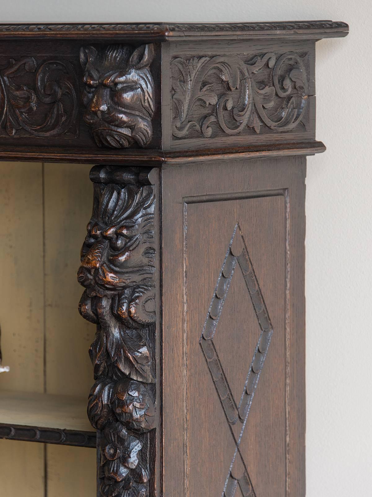 Receive our new selections direct from 1stdibs by email each week. Please click Follow Dealer below and see them first!

The open shelved English display cabinet or bookcase, circa 1890 of oak features a bold array of well carved motifs. Please
