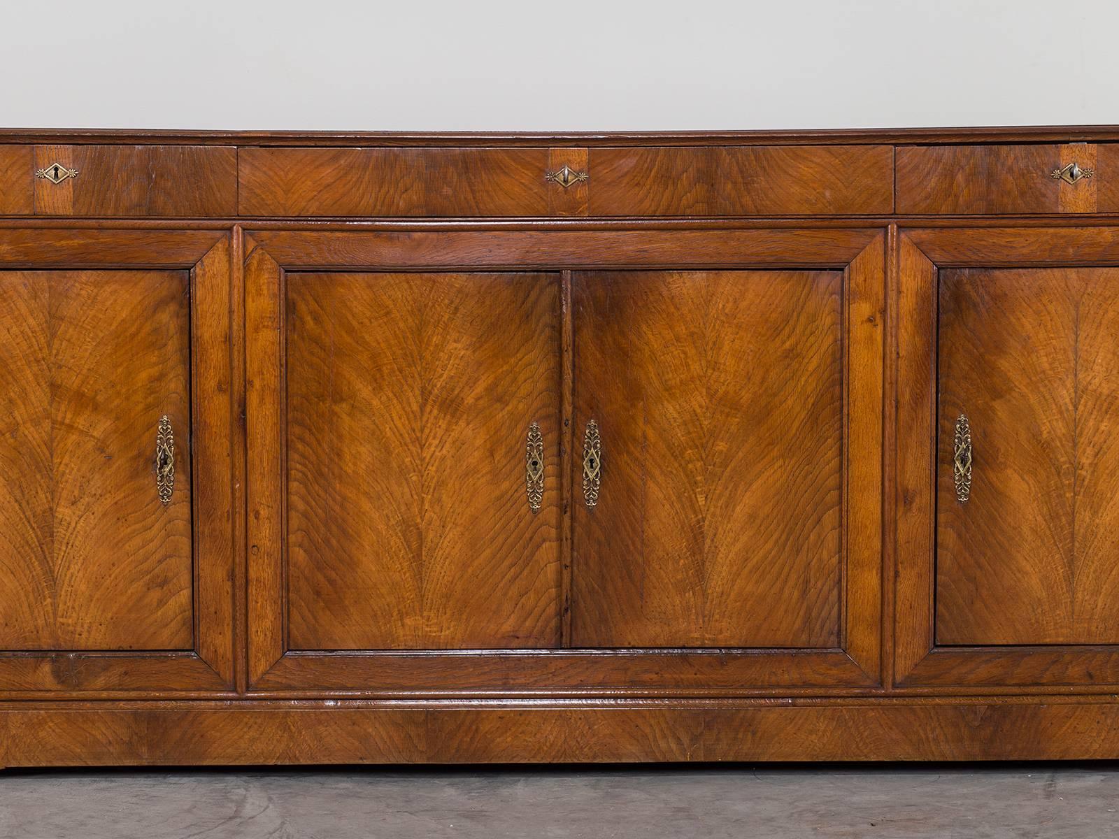 Receive our new selections direct from 1stdibs by email each week. Please click Follow Dealer below and see them first!

This exceptional antique French buffet enfilade circa 1840 showcases superb cabinet making. The beauty of the bookmatched elm