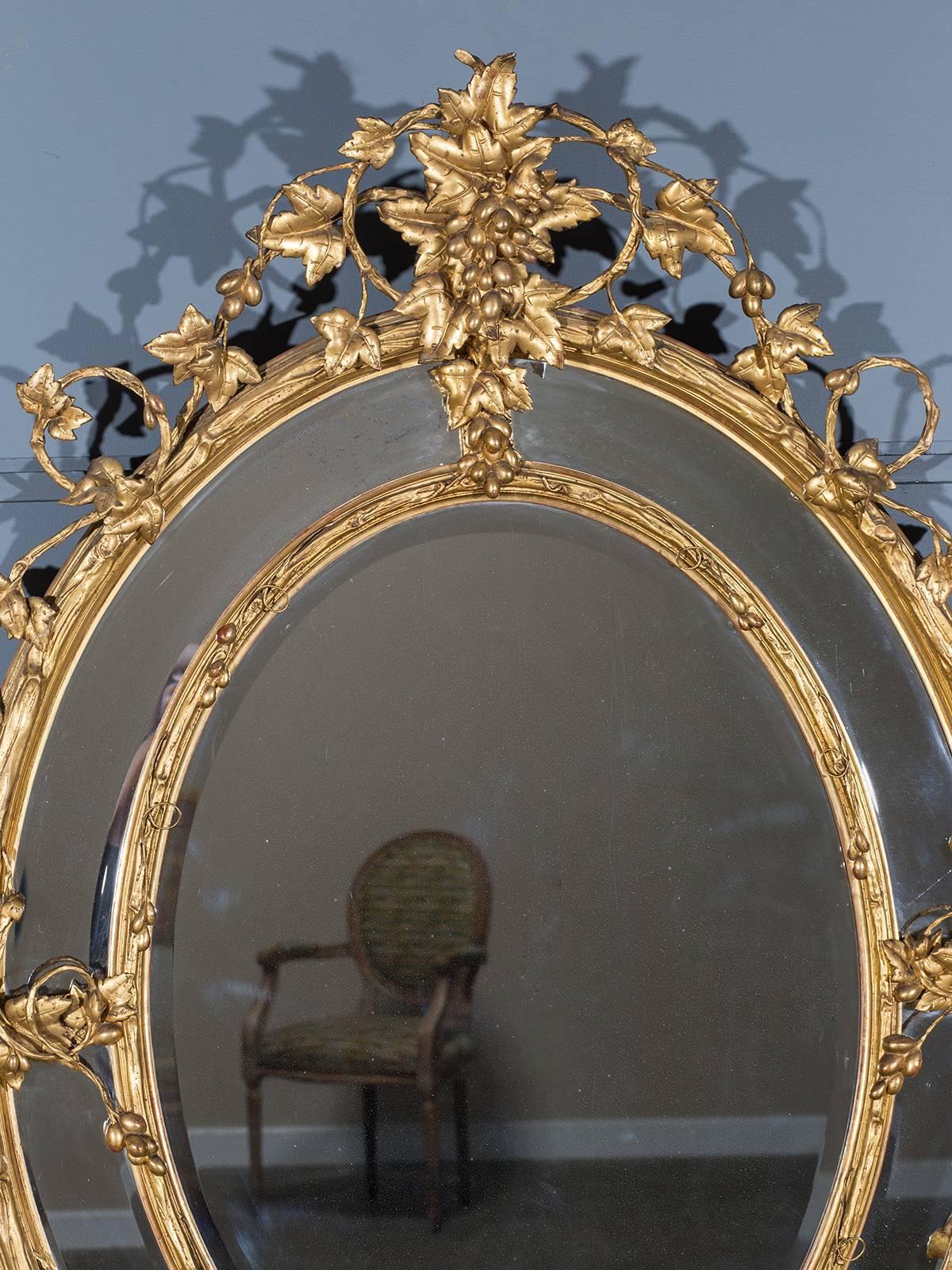 Receive our new selections direct from 1stdibs by email each week. Please click Follow Dealer below and see them first!

The beautiful oval of this antique gold leaf French mirror circa 1875 is wreathed with a trailing vine of grape leaves and