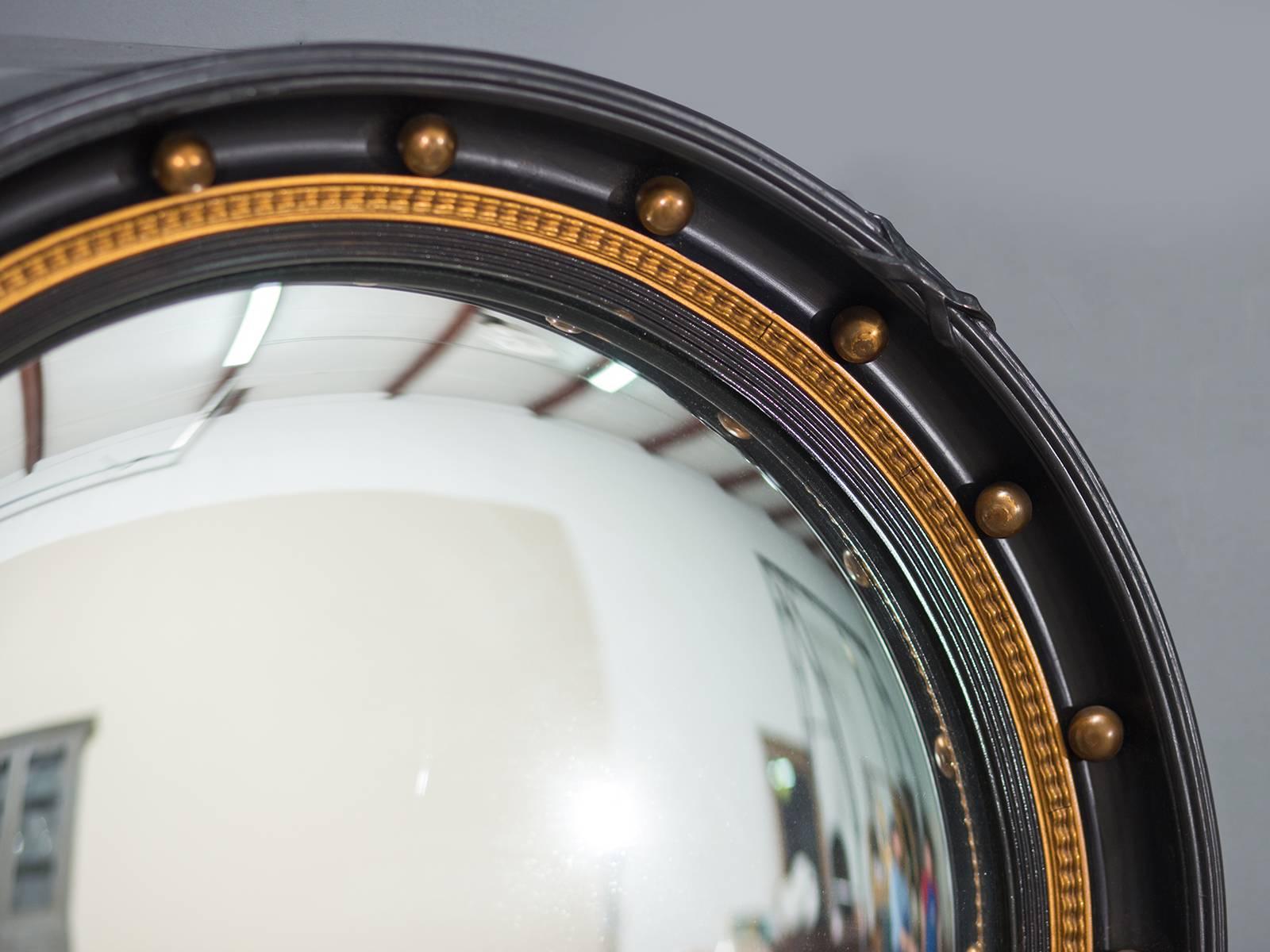 Receive our new selections direct from 1stdibs by email each week. Please click Follow Dealer below and see them first!

The graphic quality of this black painted Regency style circa 1900 convex mirror along with gilded highlights gives it a