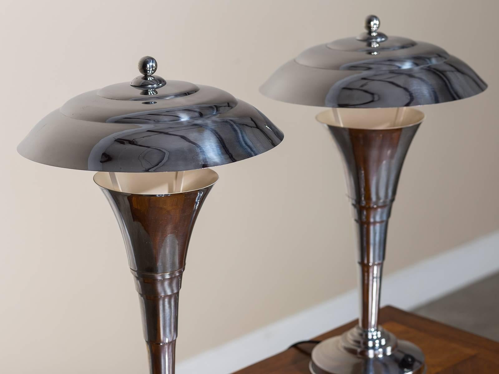 The elegant simplicity of these French Art Deco period chrome table lamps circa 1935 fits the aesthetic developed during the first quarter of the twentieth century when a streamlined effect was desirable in furnishings. Notice how the gentle curve