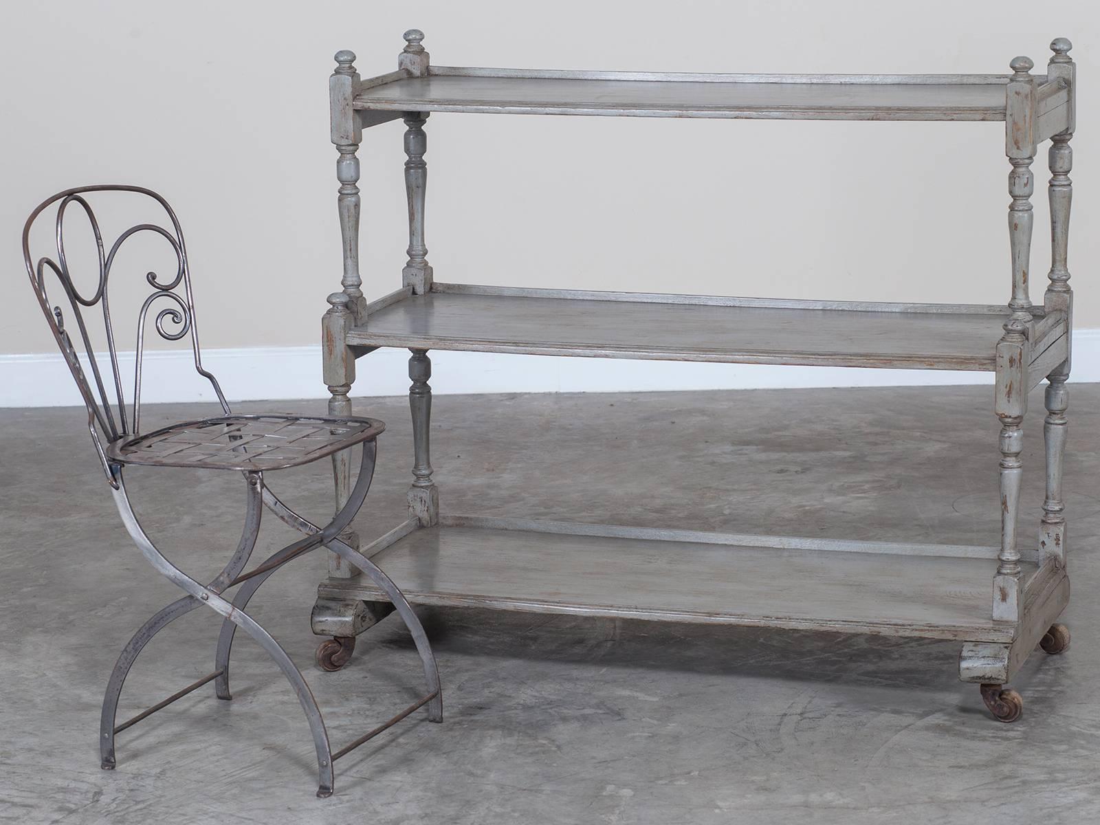 Receive our new selections direct from 1stdibs by email each week. Please click Follow Dealer below and see them first!

This useful antique English painted oak etagere table circa 1875 has three shelves and retains its original casters. Please