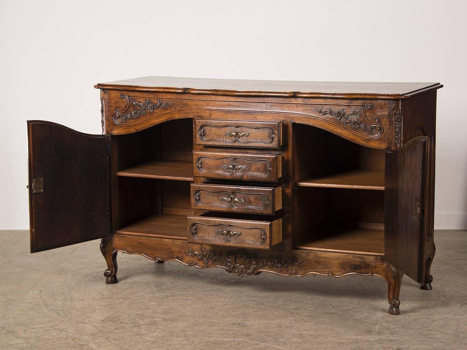 A beautiful antique French Belle Époque period Louis XV style buffet, circa 1895. Please notice the luscious curves and carving on this elegant buffet. The top has a lively undulating shape across the front along with a deeply moulded edge that