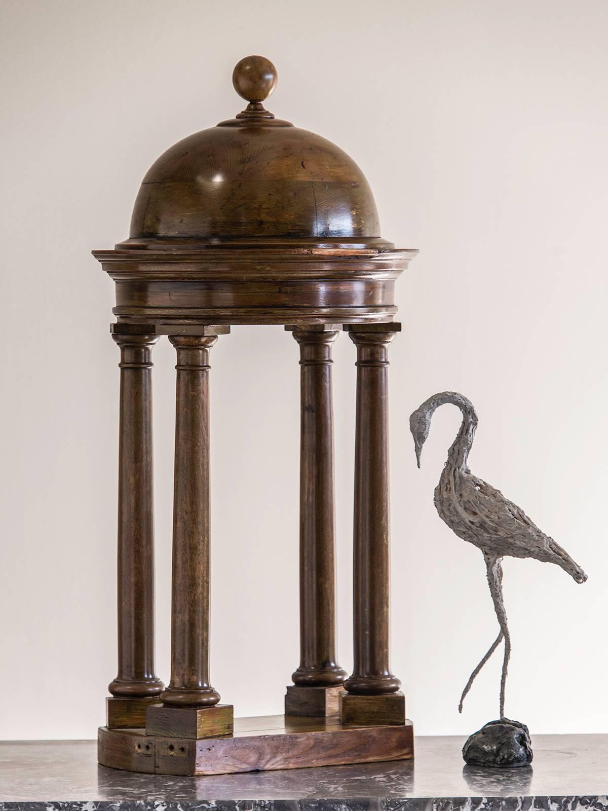 A handsome antique Italian walnut architectural model of a baldachin from Italy circa 1870. This tabletop model was crafted after Michaelangelo's superb structure in St. Peter's at the Vatican in Rome. The dramatic dome is topped with a finial in