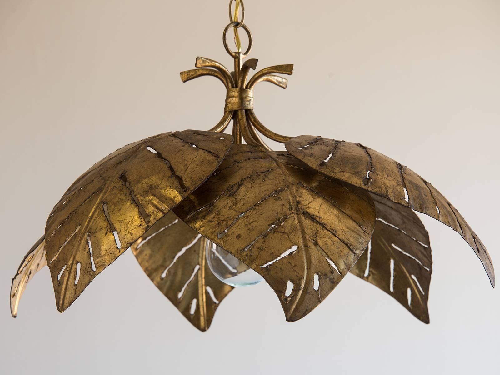 Vintage French gilded Mid-Century palm leaf chandelier, circa 1960. This circular fixture showcases six large palm leaves suspended from a chain. Please notice the handmade texture especially visible around the edge of each leaf as well as the