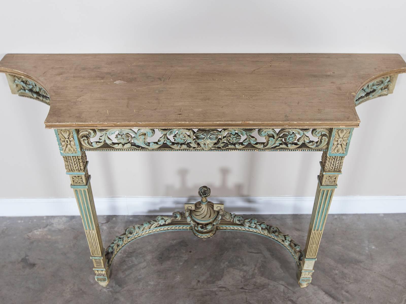 This handsome antique French neoclassical painted console table, circa 1890 showcases a series of motifs that give it a desirable presence in an interior. Completely finished so it may be seen from all directions this Louis XVI style console table