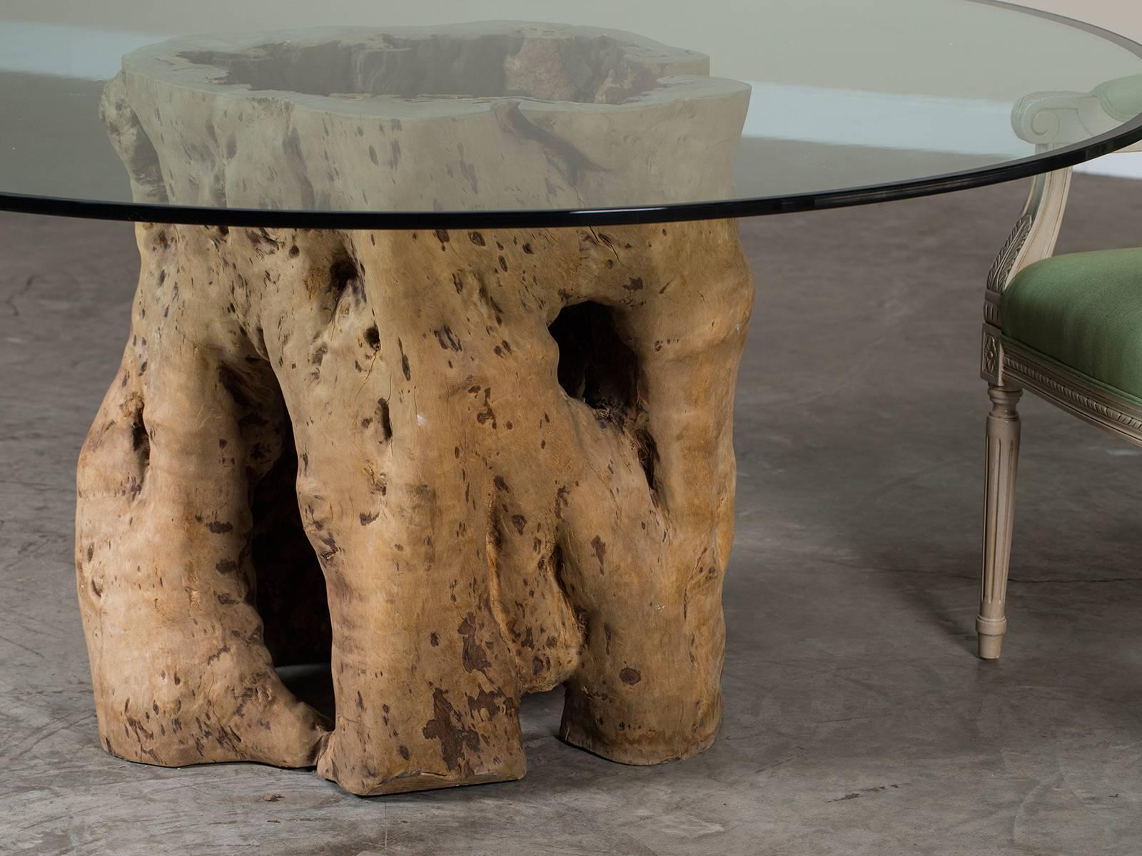 round glass table with tree trunk base