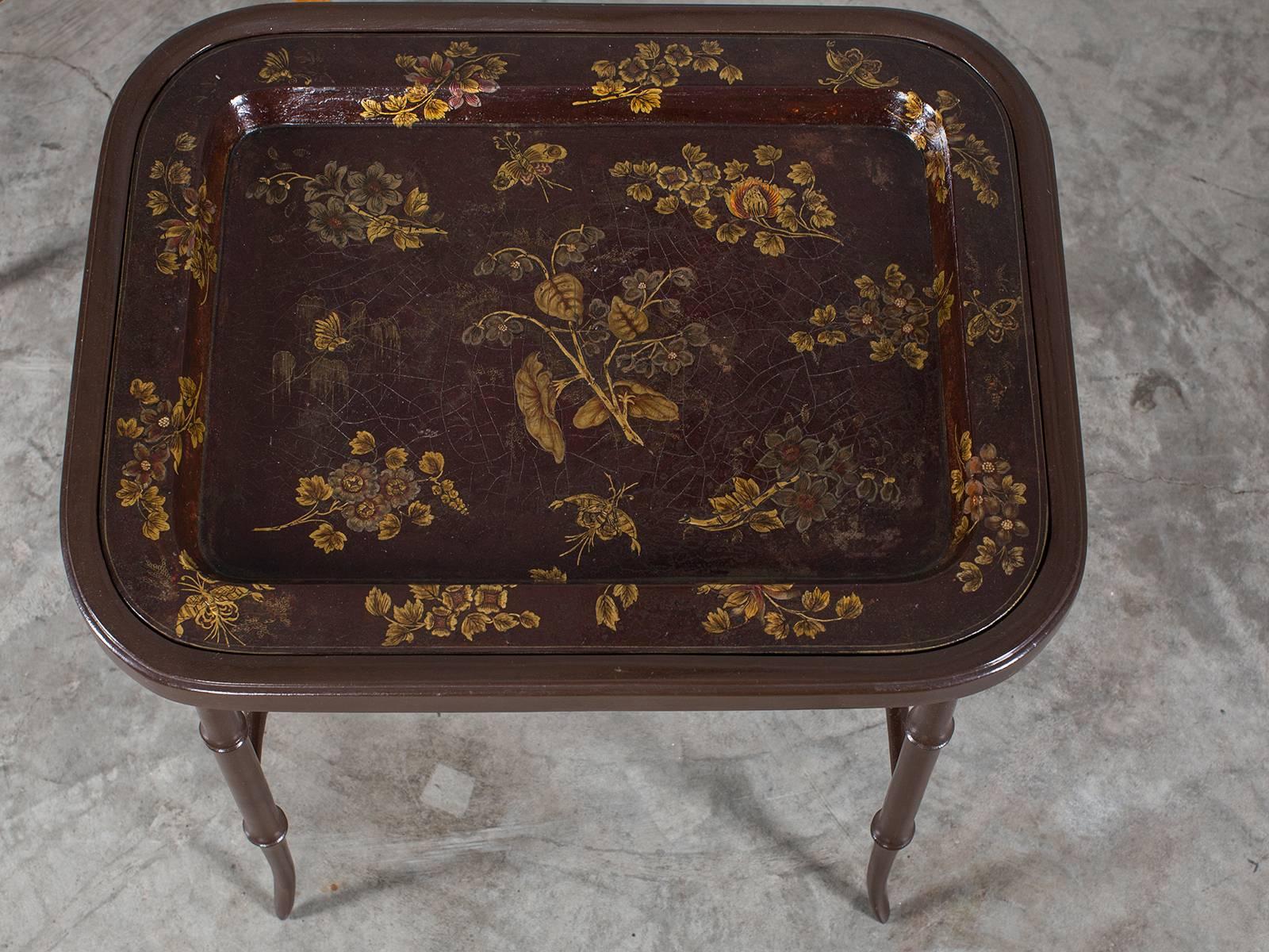 
A large antique French hand-painted tôle tray from the Belle Époque period circa 1890 now mounted on a custom stand. Please notice the unique deep caramel color highlighted with gold designs on the tray and the exceptionally well made custom stand