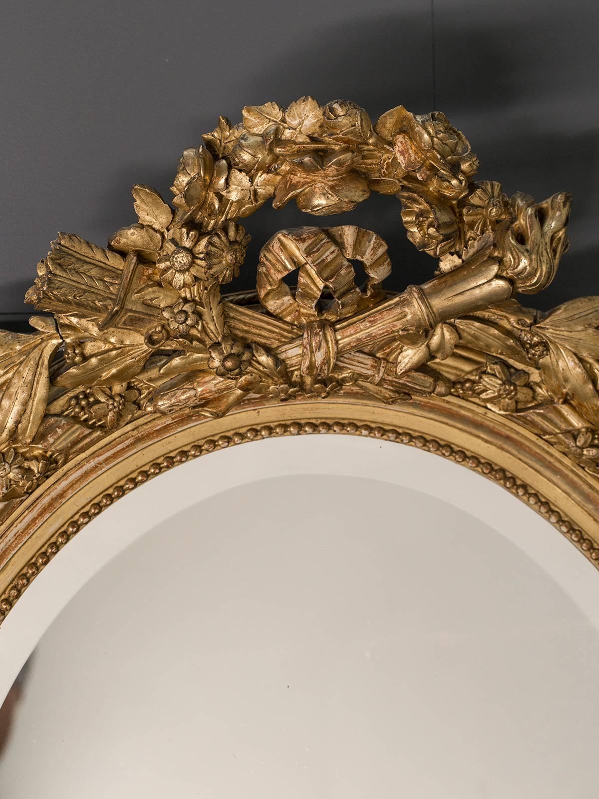 Receive our new selections direct from 1stdibs by email each week. Please click follow dealer below and see them first!

The prominent cartouche on this antique French oval mirror circa 1890 is Louis XVI in style as the crossed motif of the