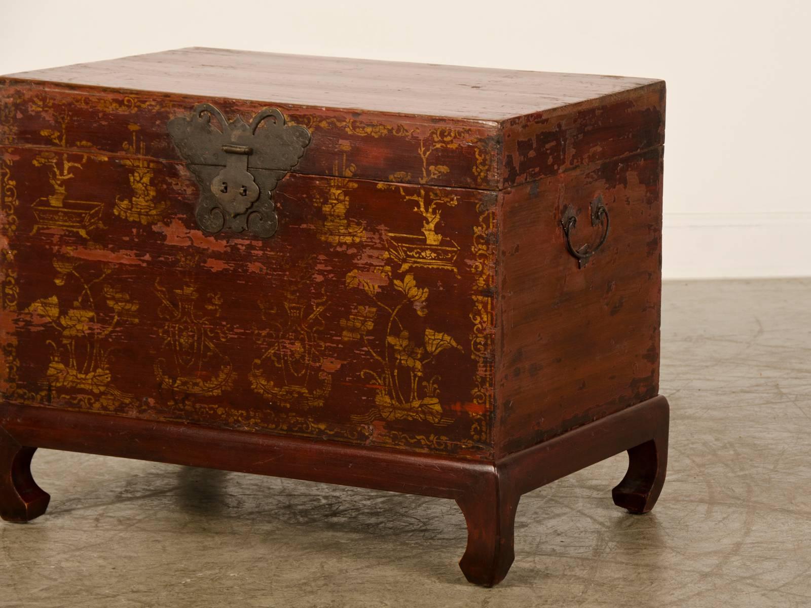Be the first to see our New Selections direct from 1stdibs! Please click on follow below. 

A red lacquer antique Chinese trunk having gilt gold painted decoration Kuang Hsu period, circa 1875 with the original metal hardware now raised on a