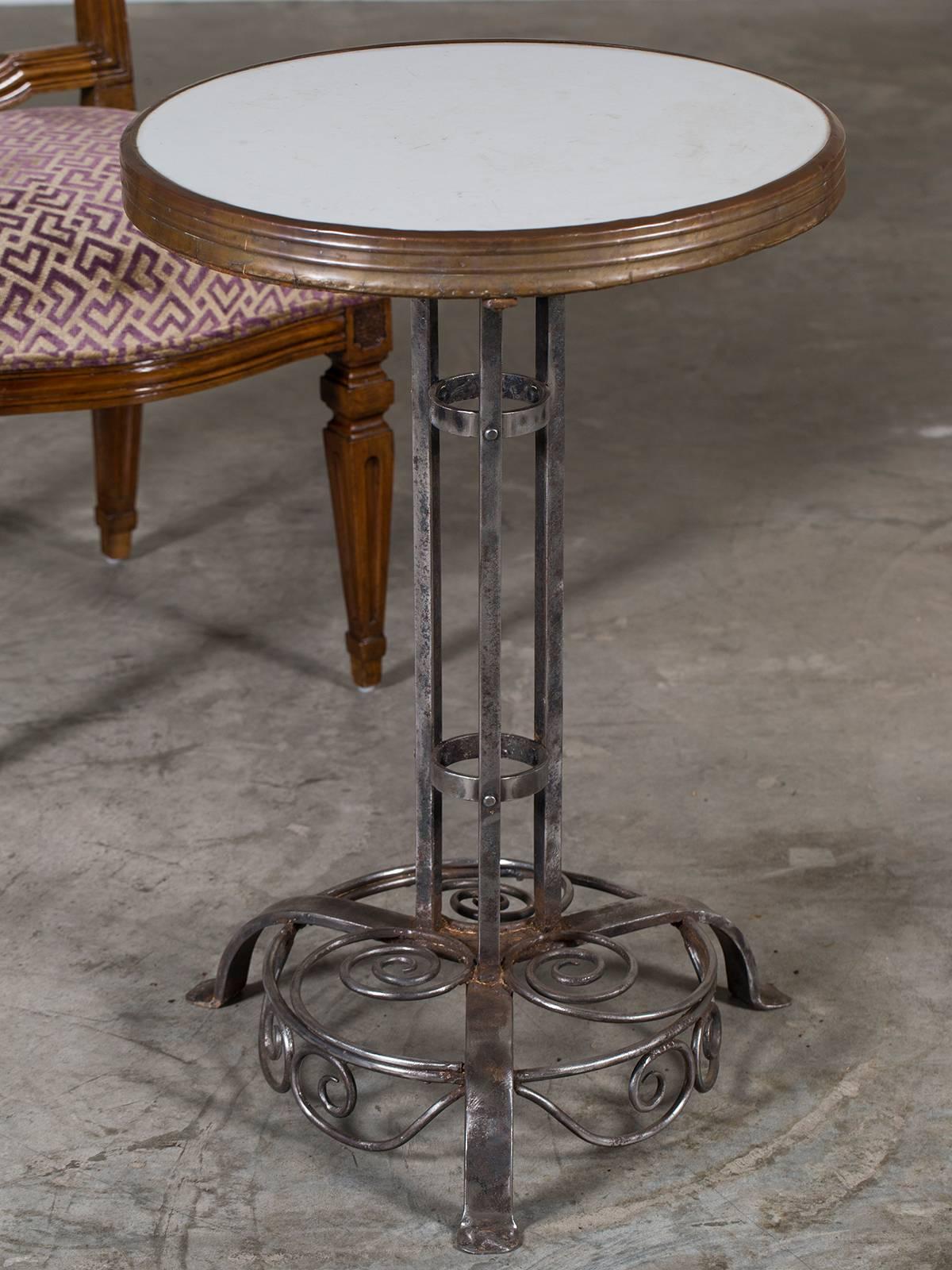 Be the first to see our new selections direct from 1stdibs! Please click on follow below.

A striking antique German iron cafe bistro table from Munich, circa 1910. The central column has three vertical supports joined by two rings on the
