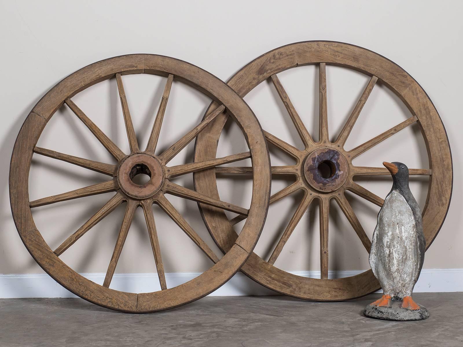 Be the first to see our new listings direct from 1stdibs! Please click "Follow" below.

This pair of enormous antique French wagon wheels, circa 1880 are wonderful artifacts from a bygone era in France. Please notice the construction was