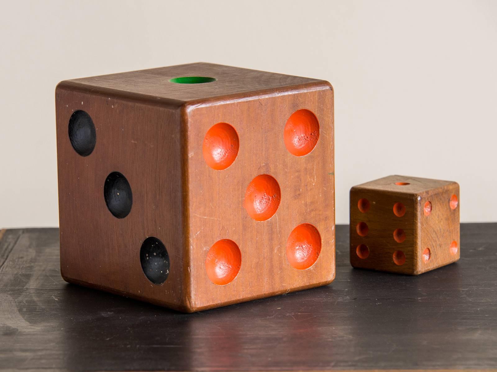 A collection of two vintage wooden dice from France, circa 1940. Please notice the intriguing differences both in the scale of these two dice as well as the combination of paint used to highlight their background and numbered sides. These were