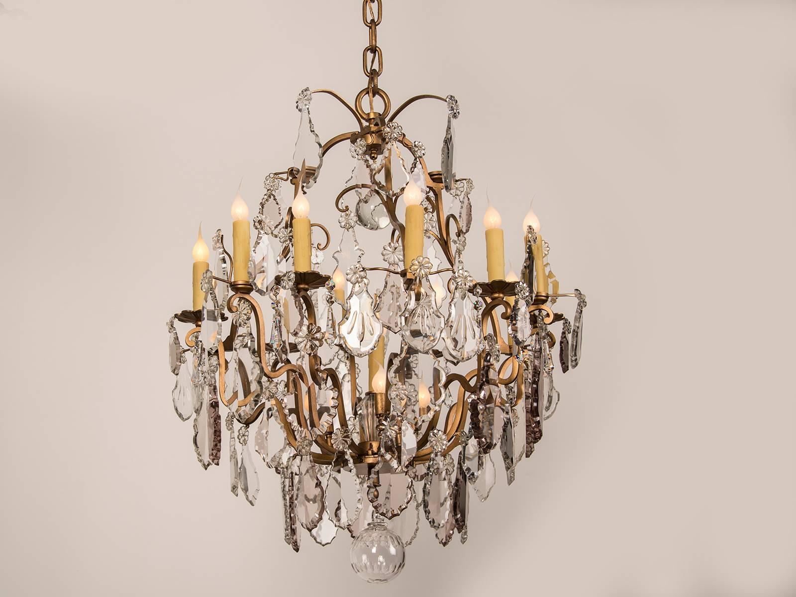 A beautiful antique French Louis XV style crystal chandelier with sixteen lights from France circa 1900 of large scale. The unusual feature of this grand chandelier lies in its allocation of lights. Around the perimetre of the chandelier is an
