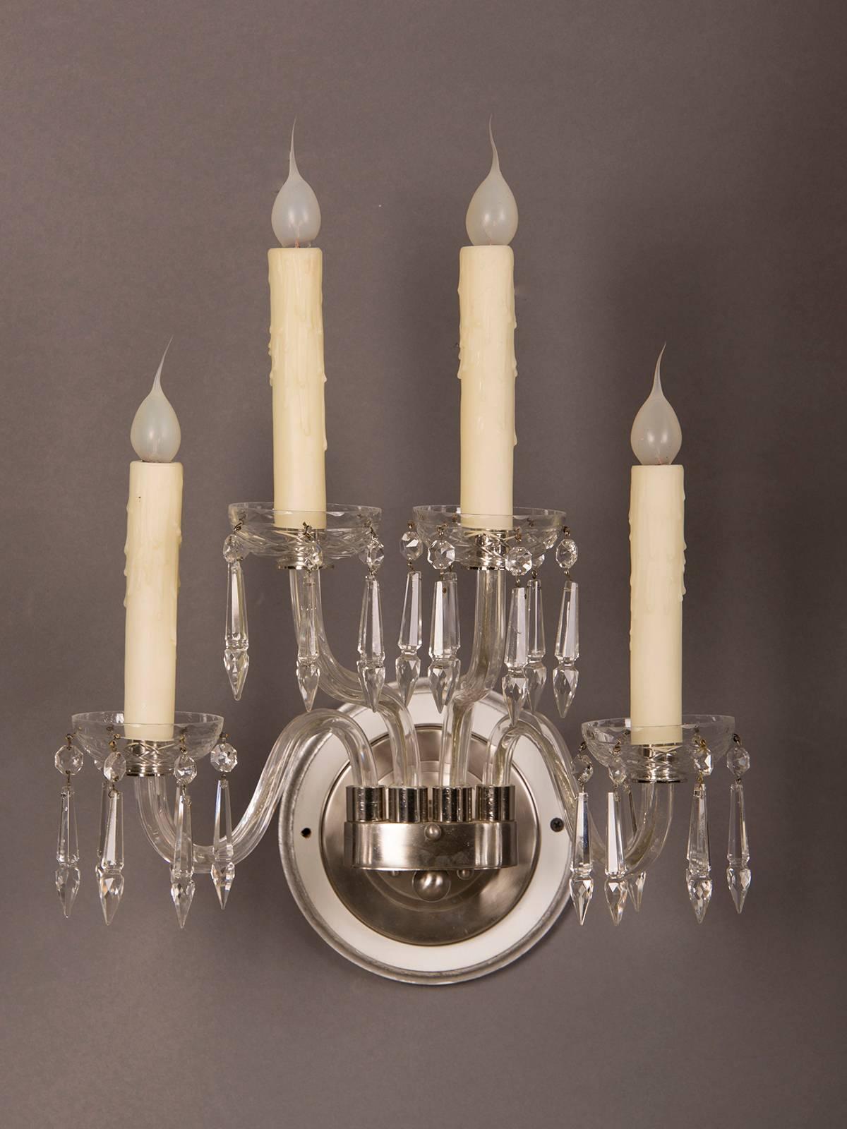 A pair of vintage George III style four arm cut-glass sconces set with a nickel frame from England, circa 1940. Please look at the elegant profile of these sconces that follow the original eighteenth century examples but with a modern simplicity