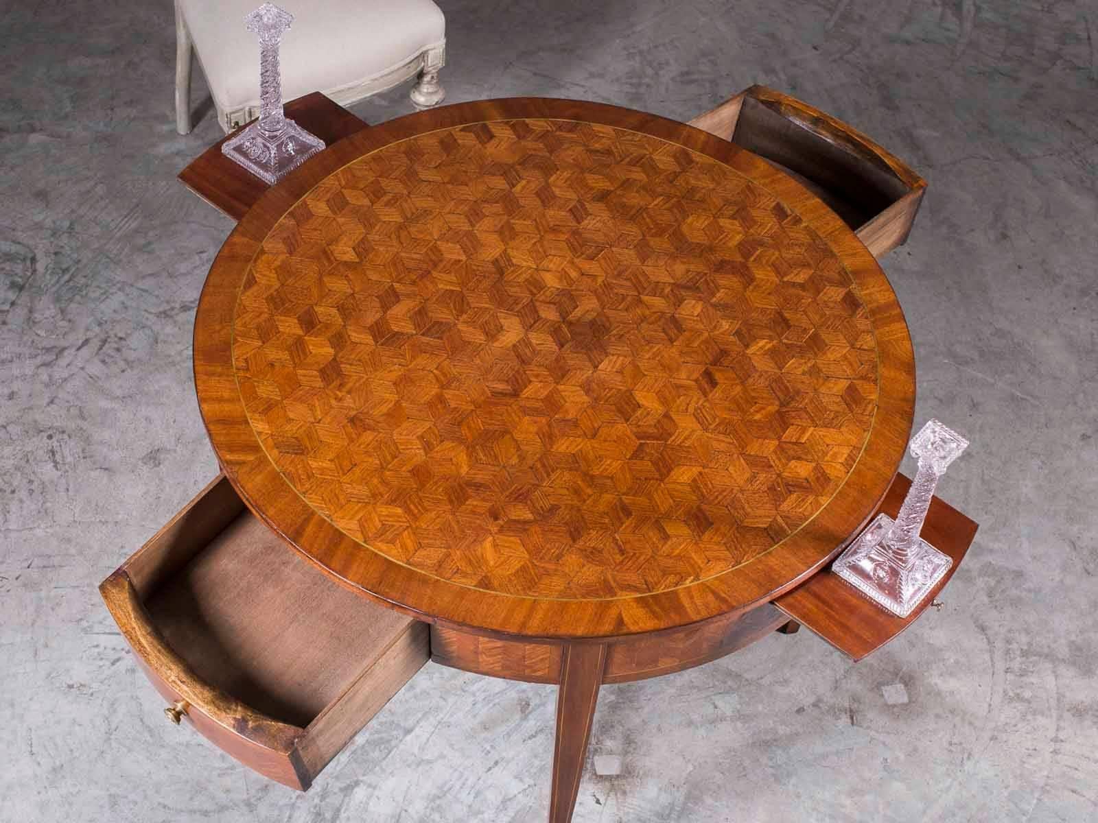 This handsome antique French Louis XVI round walnut table from France circa 1885 features a parquet top and apron along with two drawers and two candle slides. In the eighteenth century gambling was a common pastime and game tables were an essential