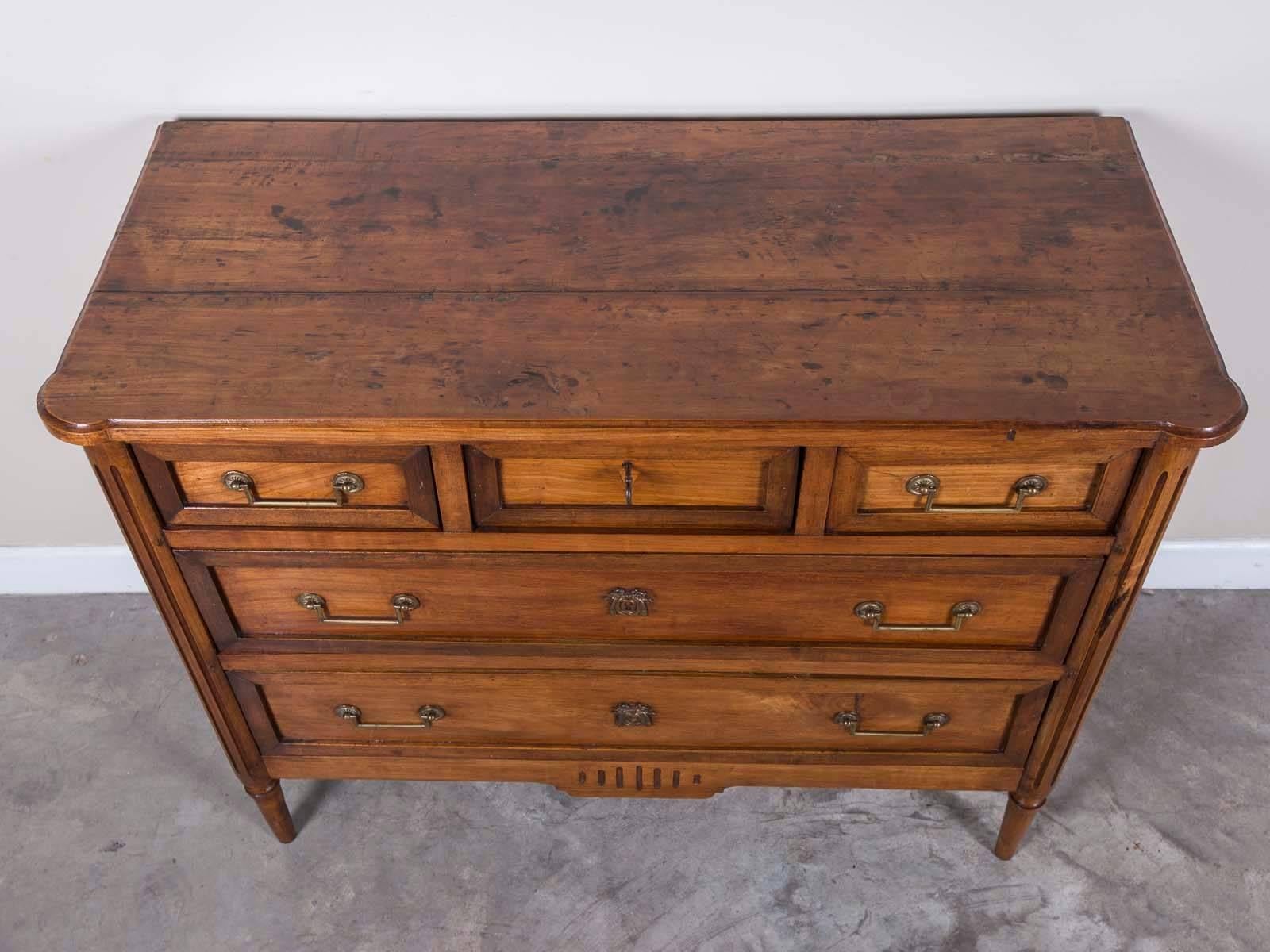 The gorgeous honey caramel color on this antique French Louis XVI walnut chest of drawers circa 1790 is an absolute pleasure to behold. Polished to a lustrous patina this French walnut chest has three drawers at the top with two lower wider drawers