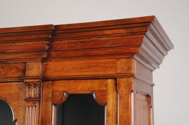 A handsome and well-proportioned antique French neoclassical style walnut bibliotheque, circa 1875. Please notice the luscious walnut used in the creation of this impressive piece of late nineteenth century French cabinet making. The substantial