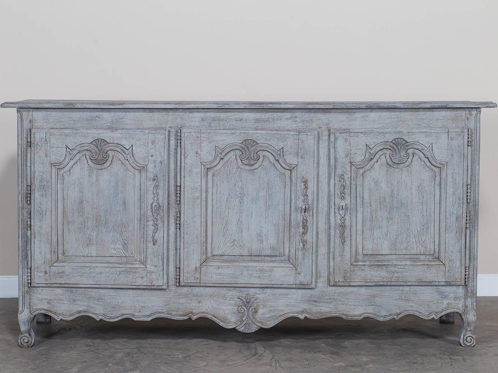 Receive our new selections direct from 1stdibs by email each week. Please click Follow Dealer below and see them first!

A large antique French Louis XV style painted oak buffet/enfilade having three-door and drawers, circa 1850.