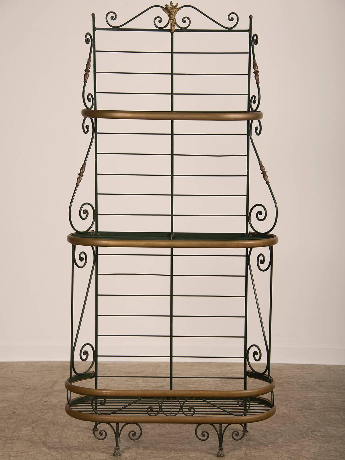 Receive our new selections direct from 1stdibs by email each week. Please click Follow Dealer below and see them first!

A vintage French iron and brass baker's rack circa 1920 standing on paw feet now with glass shelves on each level.