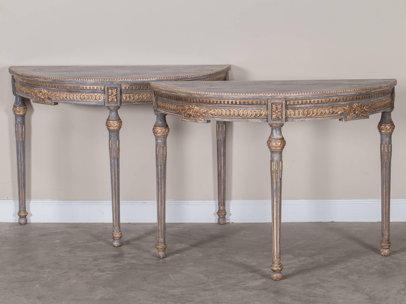 The elegant carving on this pair of Swedish console tables is highlighted with a distinctive painted and gilded finish. Known as 